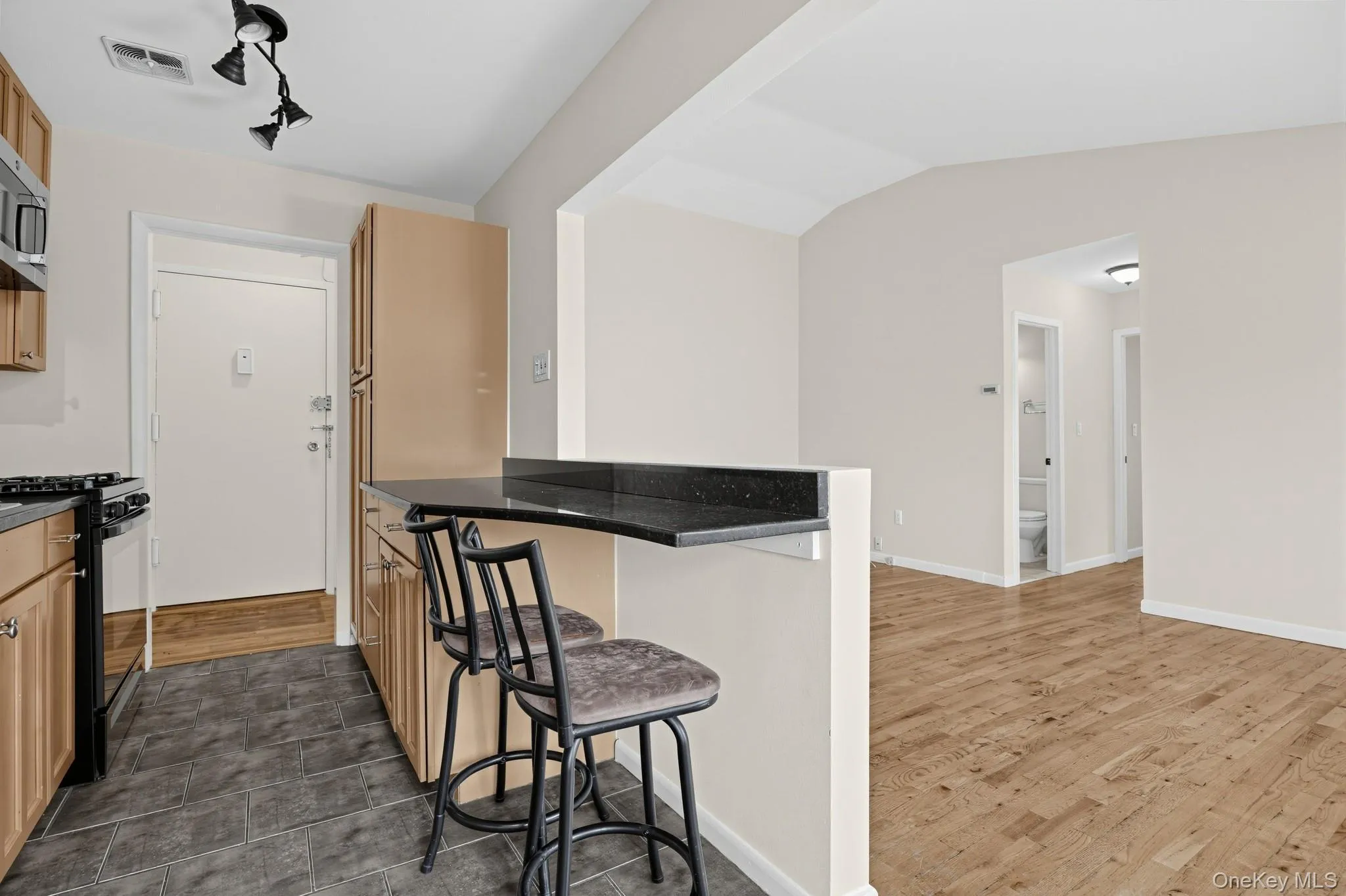 Breakfast-bar seating creates an easy connection between the kitchen and adjoining living area. Breakfast-bar seating creates an easy connection between the kitchen and adjoining living area.