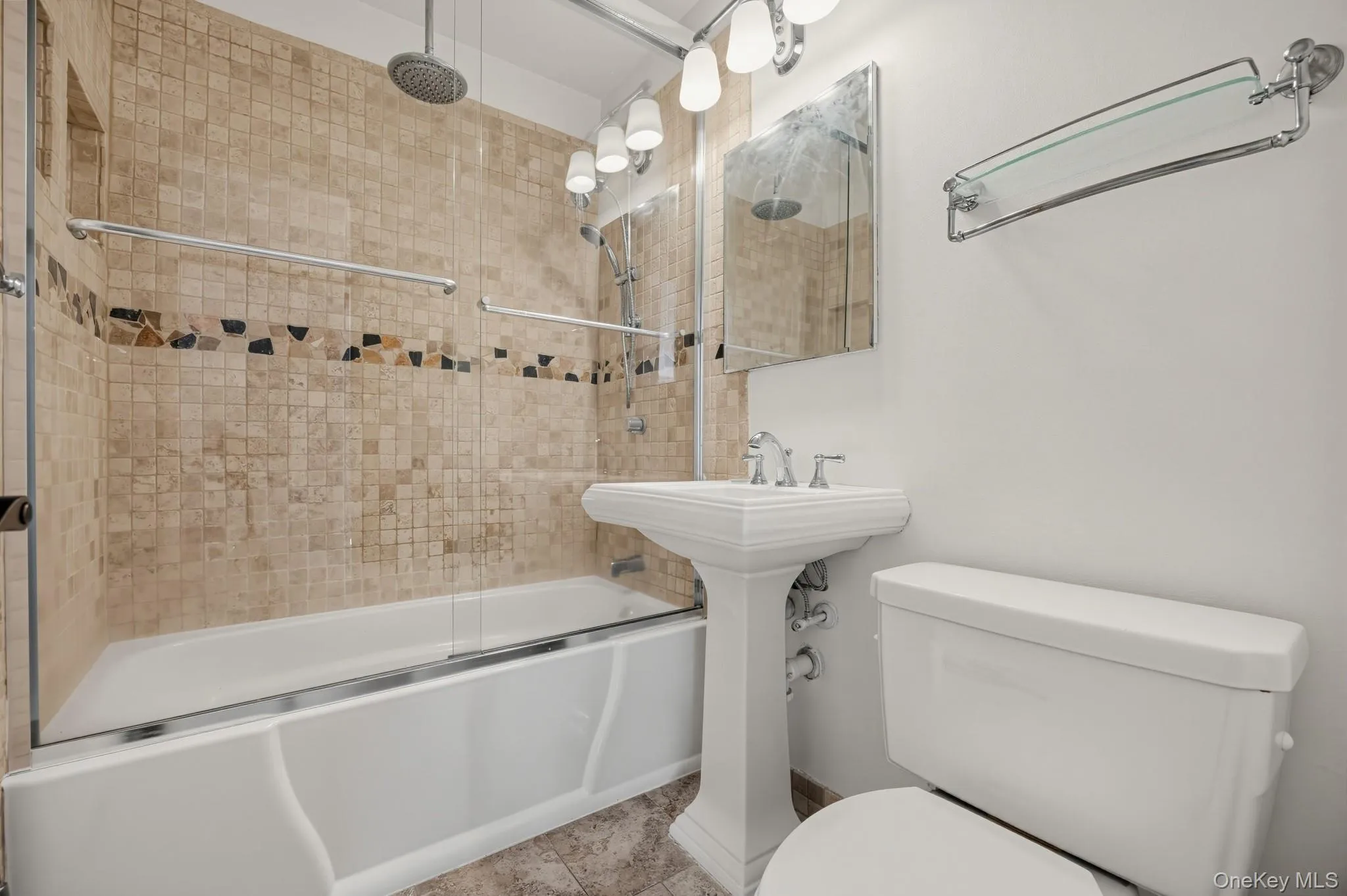 Full bath with tiled tub/shower surround, glass enclosure and classic pedestal sink. Full bath with tiled tub/shower surround, glass enclosure and classic pedestal sink.