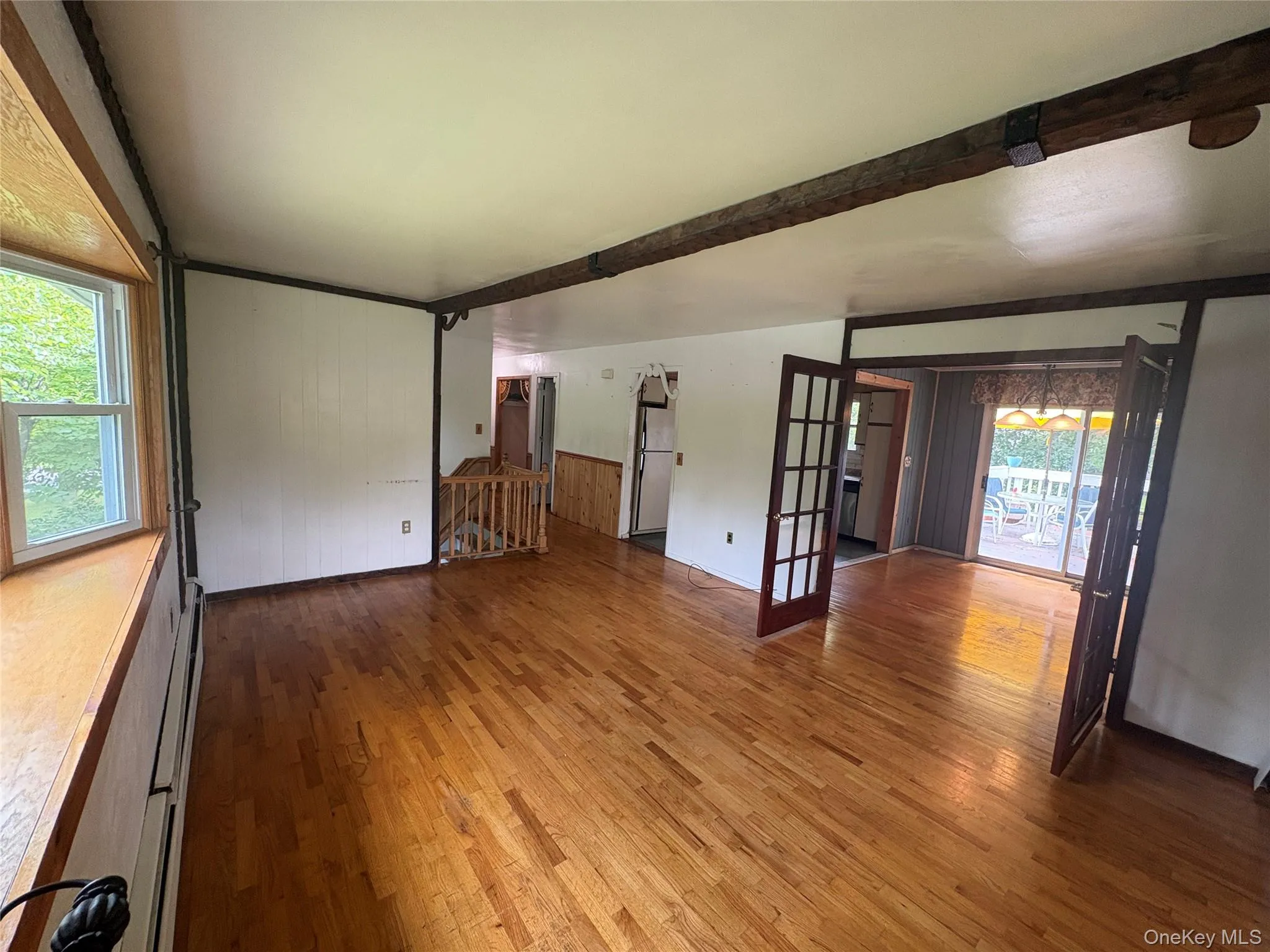 Spacious living room with hardwood floors and French doors Spacious living room with hardwood floors and French doors