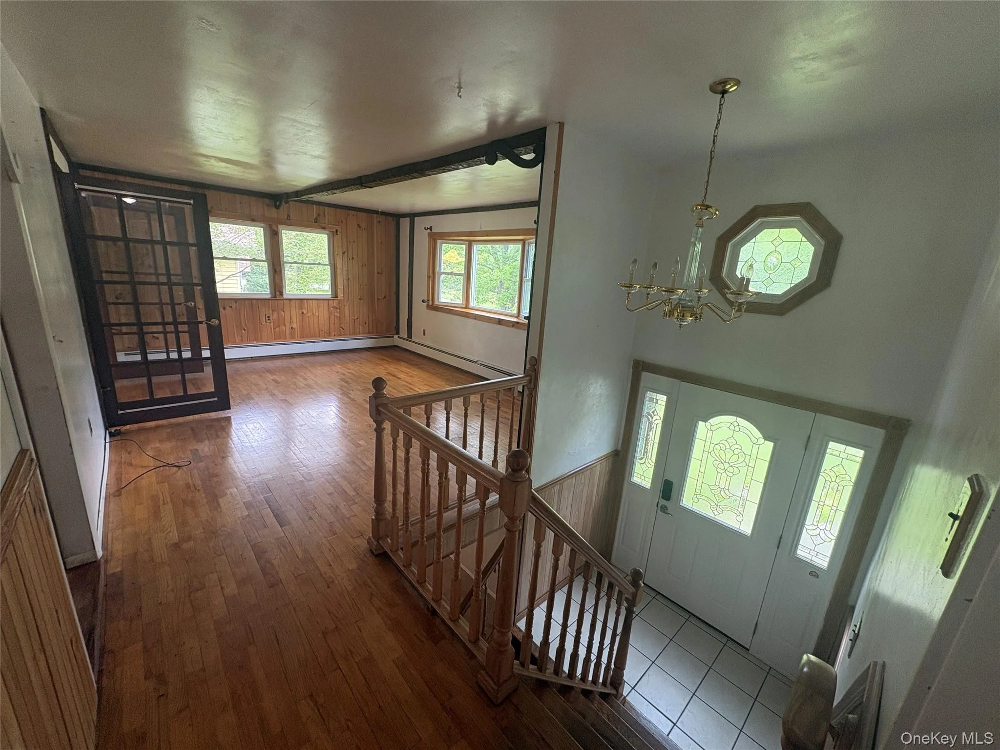 Spacious entrance foyer with hardwood flooring and staircase Spacious entrance foyer with hardwood flooring and staircase
