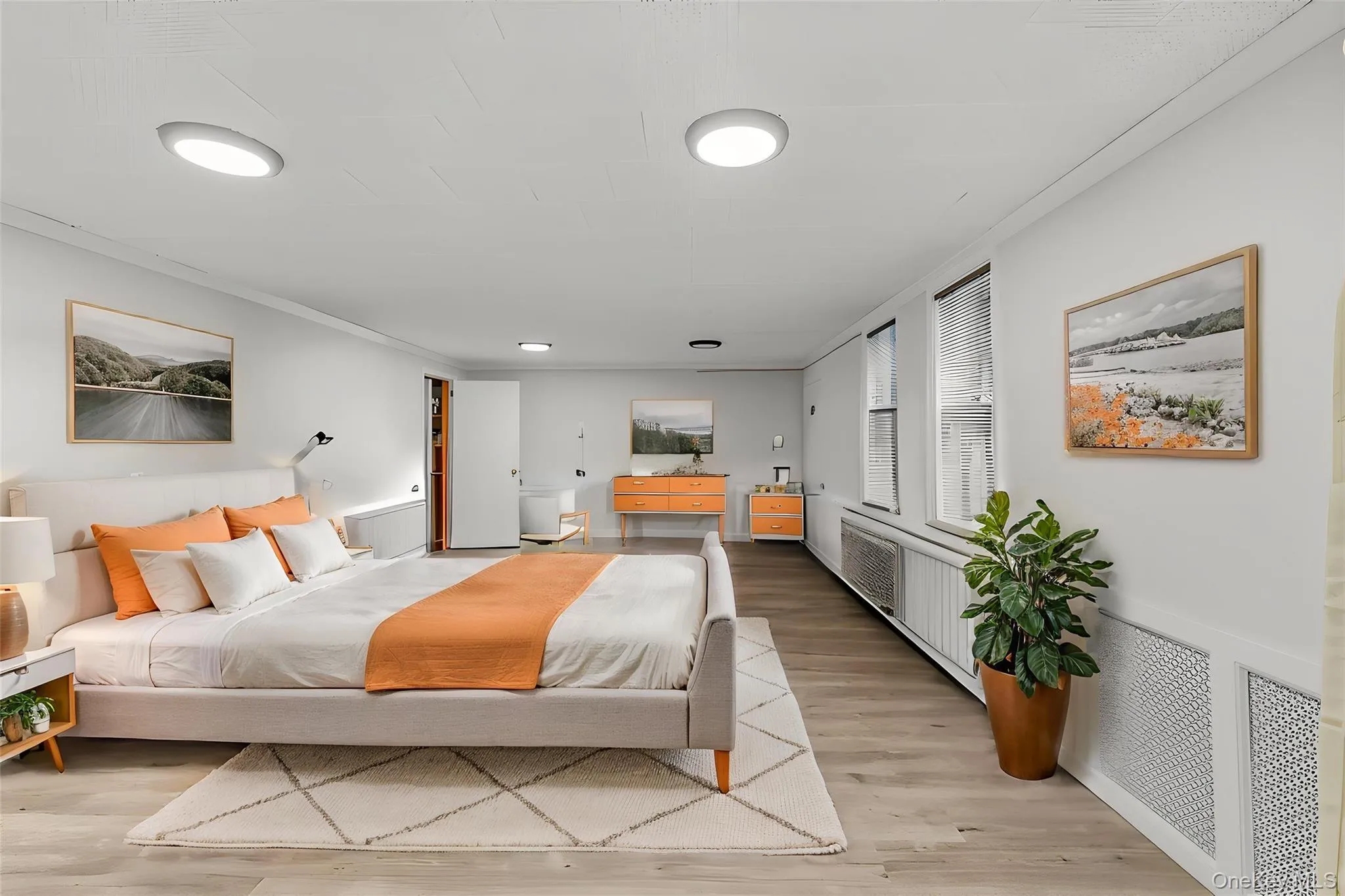 Recessed ceiling lighting, wood-finish flooring, multiple windows with blinds, and white wall finishes Recessed ceiling lighting, wood-finish flooring, multiple windows with blinds, and white wall finishes
