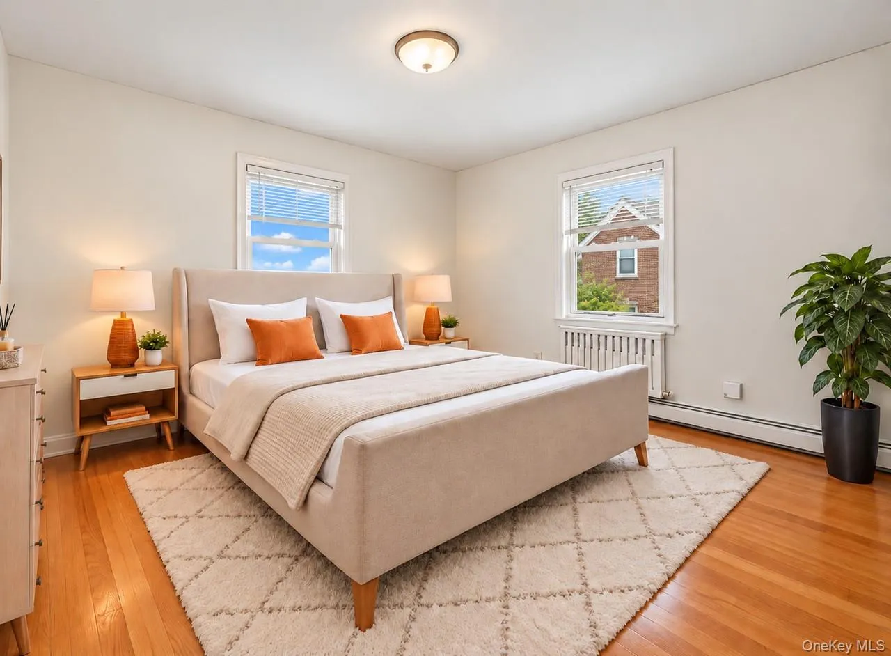 Hardwood flooring, two windows with blinds, and white walls Hardwood flooring, two windows with blinds, and white walls