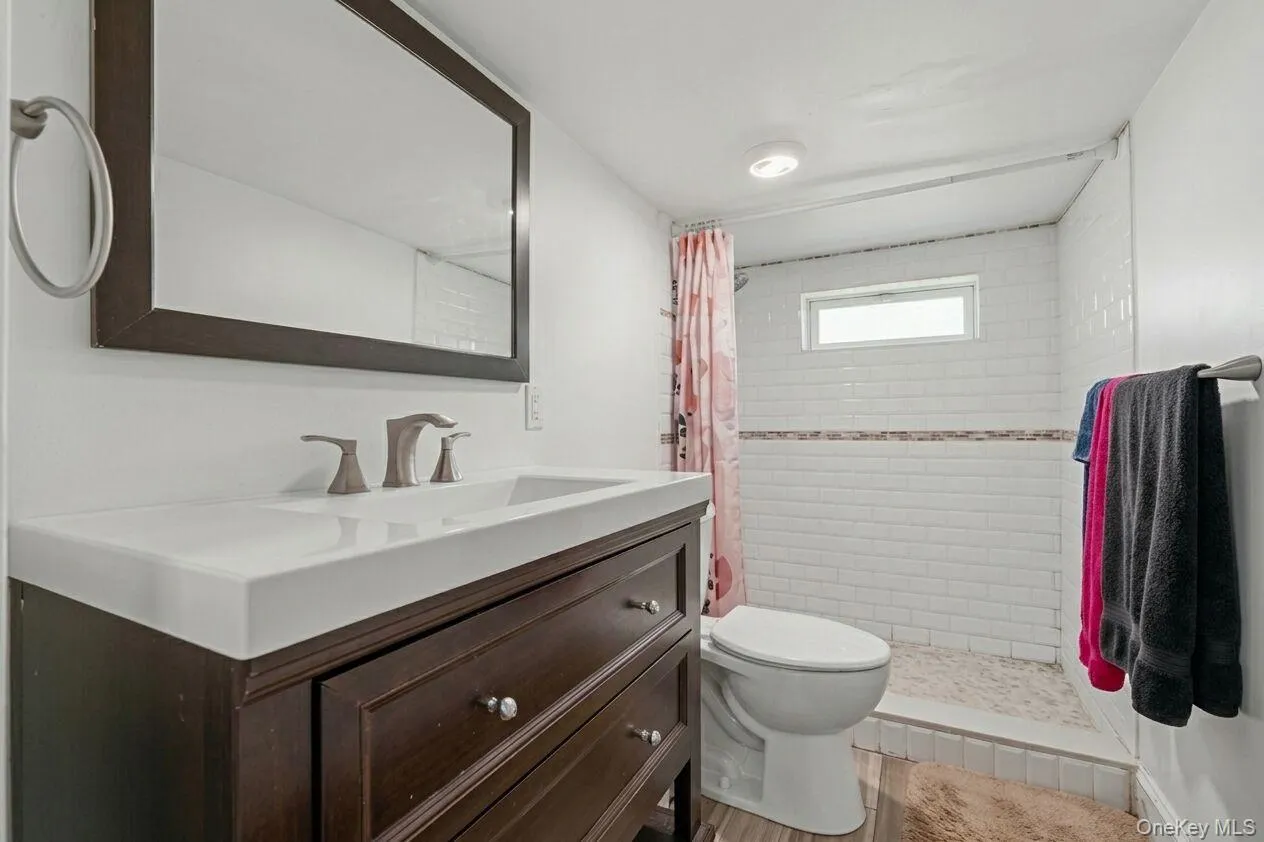 Dark wood-finish vanity with integrated sink Dark wood-finish vanity with integrated sink