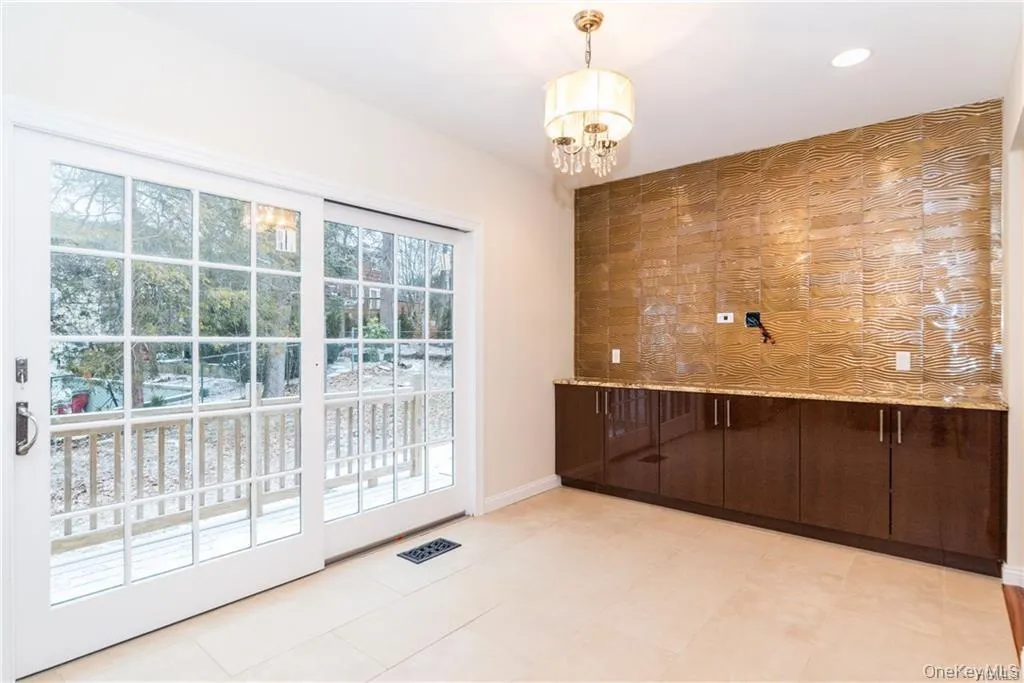 Unfurnished dining area featuring a chandelier, recessed lighting, and baseboards Unfurnished dining area featuring a chandelier, recessed lighting, and baseboards