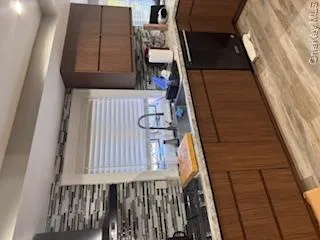 Kitchen with cooktop, decorative backsplash, and dishwashing machine Kitchen with cooktop, decorative backsplash, and dishwashing machine