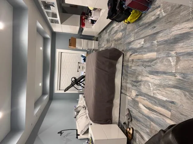 Bedroom featuring / wood-style tile floors Bedroom featuring / wood-style tile floors