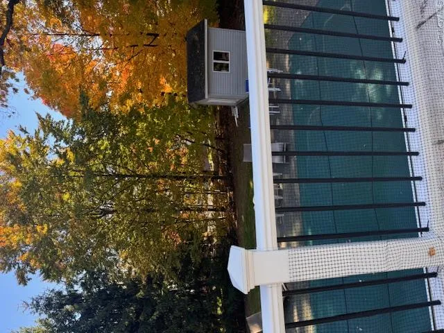 View of pool featuring a shed View of pool featuring a shed