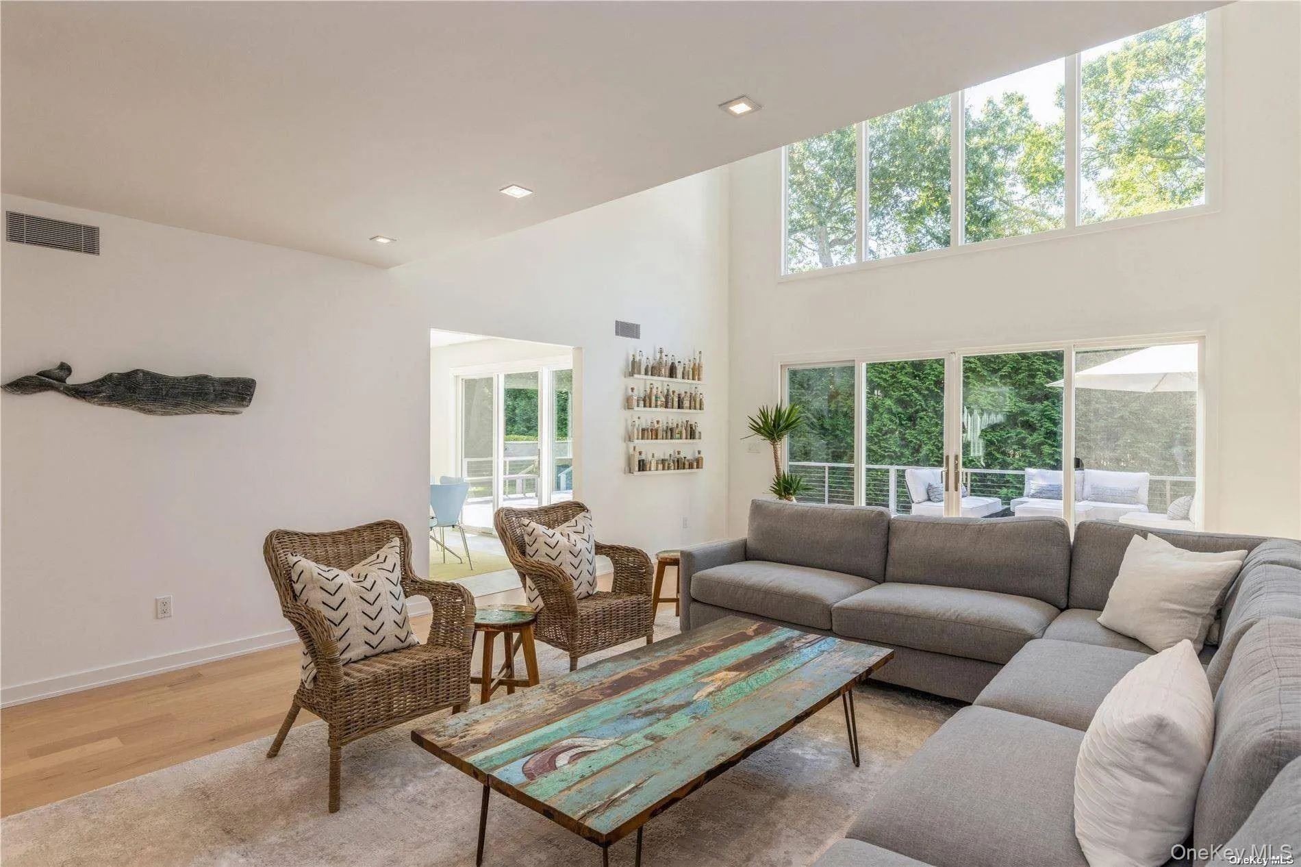 Living area with a high ceiling, wood finished floors, and recessed lighting Living area with a high ceiling, wood finished floors, and recessed lighting