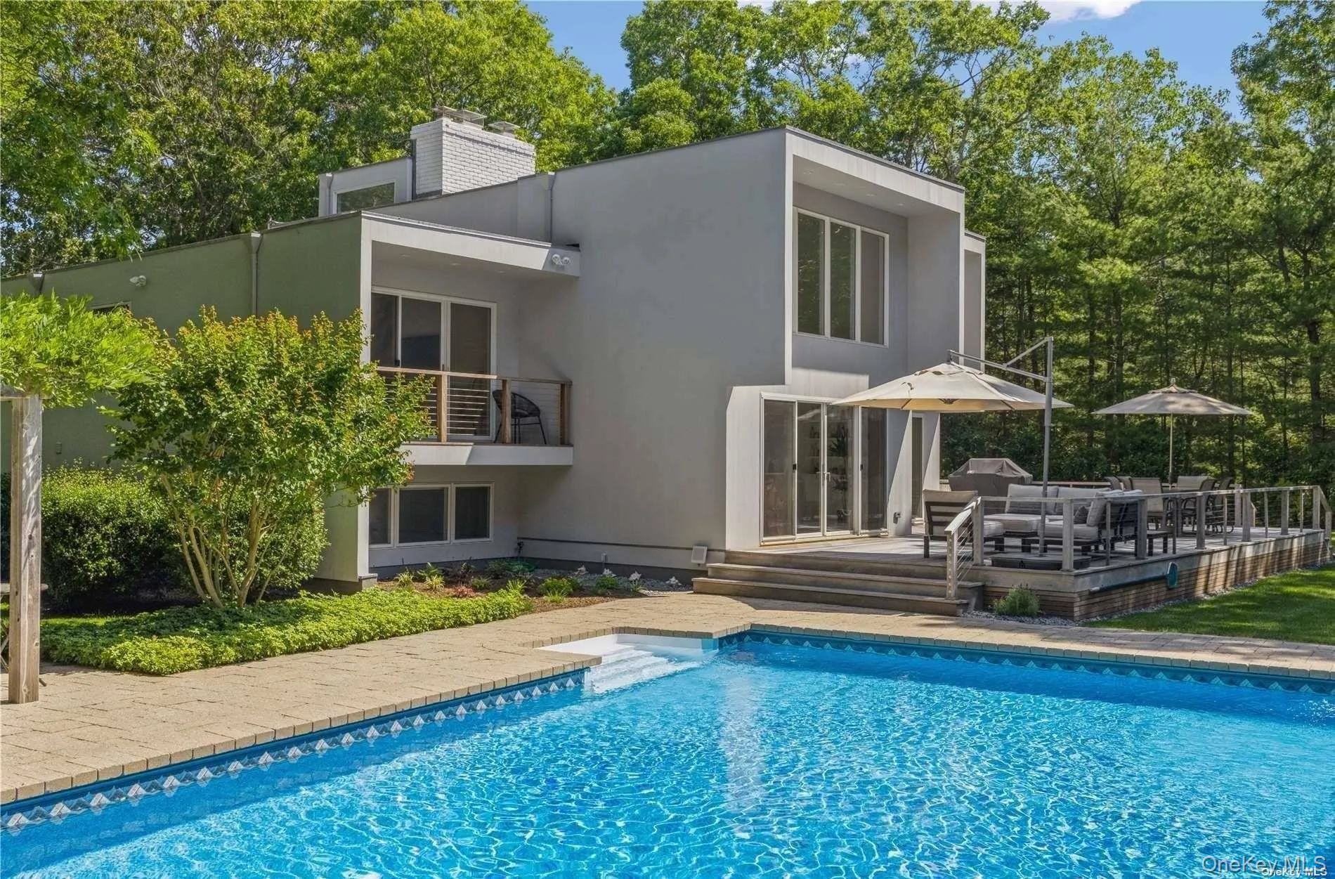 View of swimming pool featuring a patio area and a balcony View of swimming pool featuring a patio area and a balcony