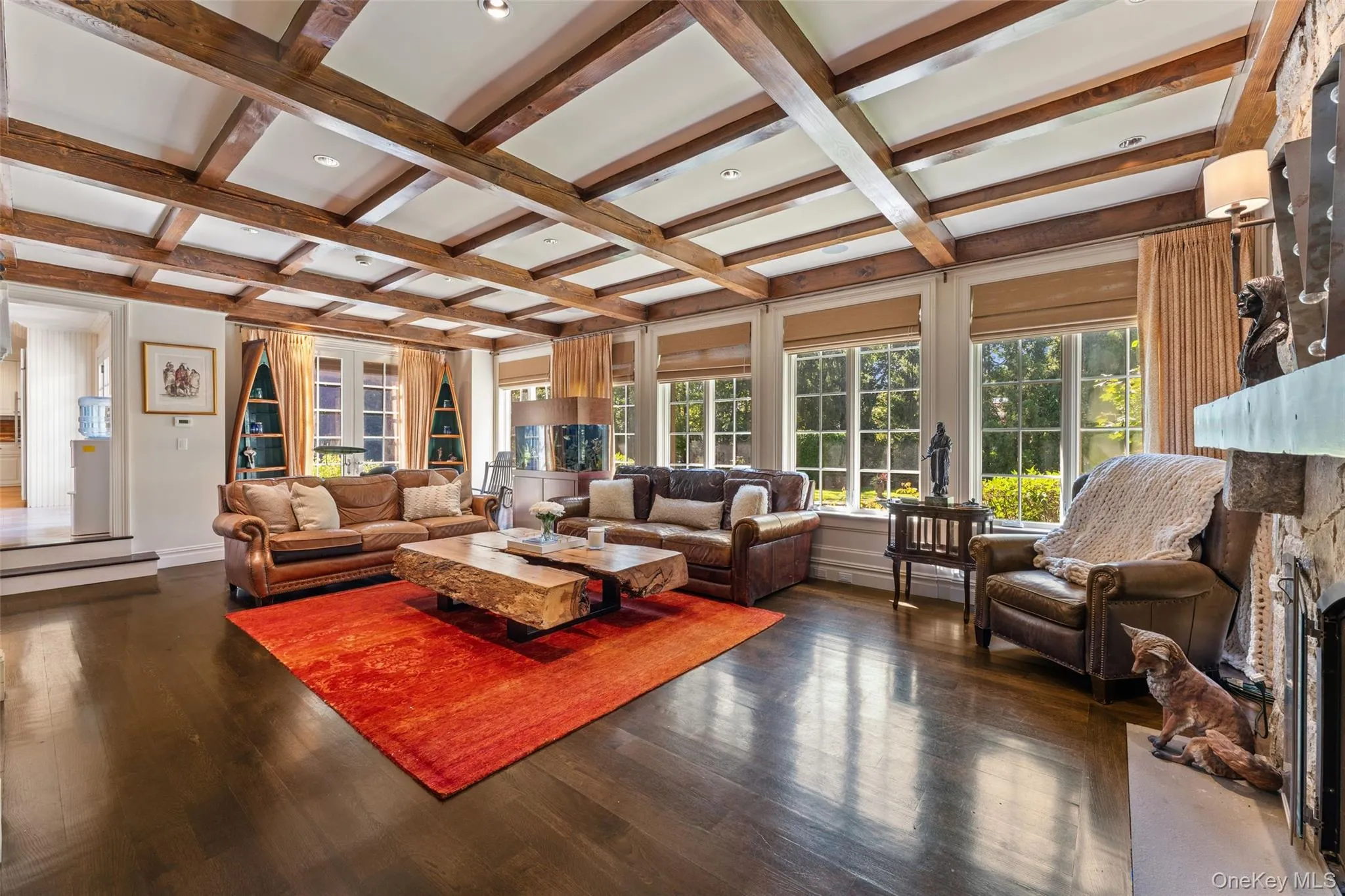 Sunken family room with a stone fireplace and coffered ceiling Sunken family room with a stone fireplace and coffered ceiling