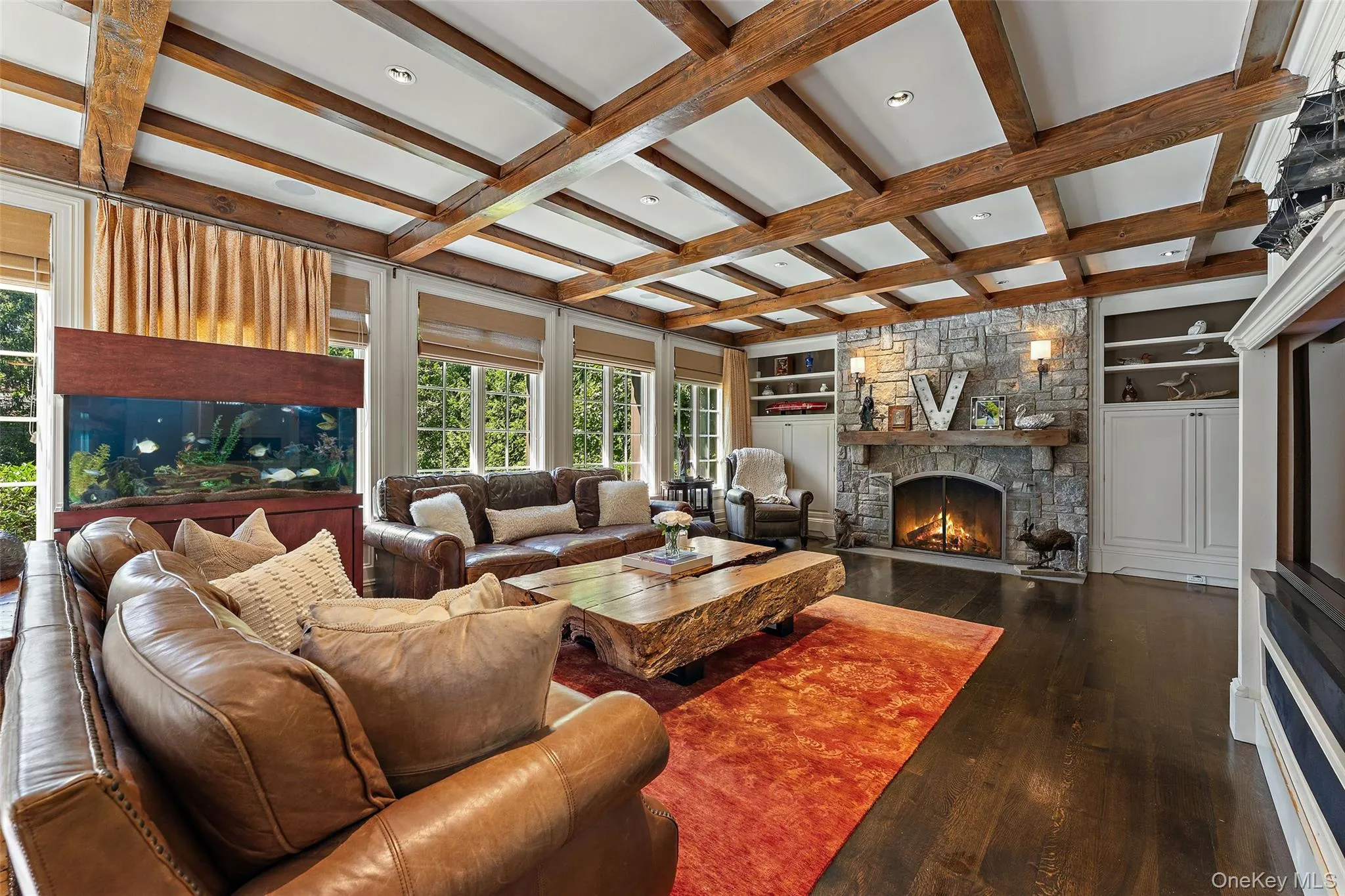 View of family room with gas fireplace and wall of windows View of family room with gas fireplace and wall of windows