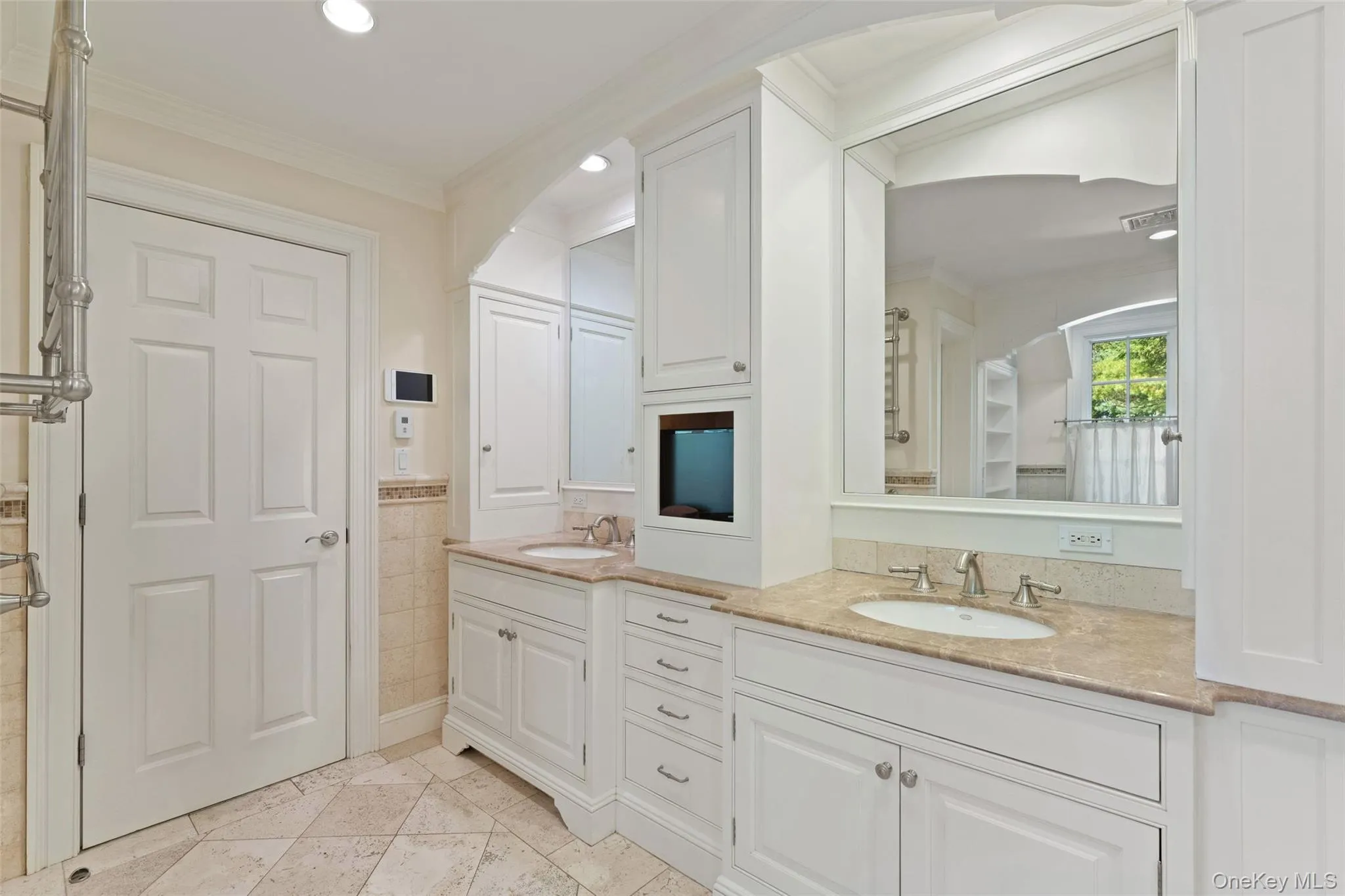 Primary bathroom with double vanities and radiant heated floors Primary bathroom with double vanities and radiant heated floors