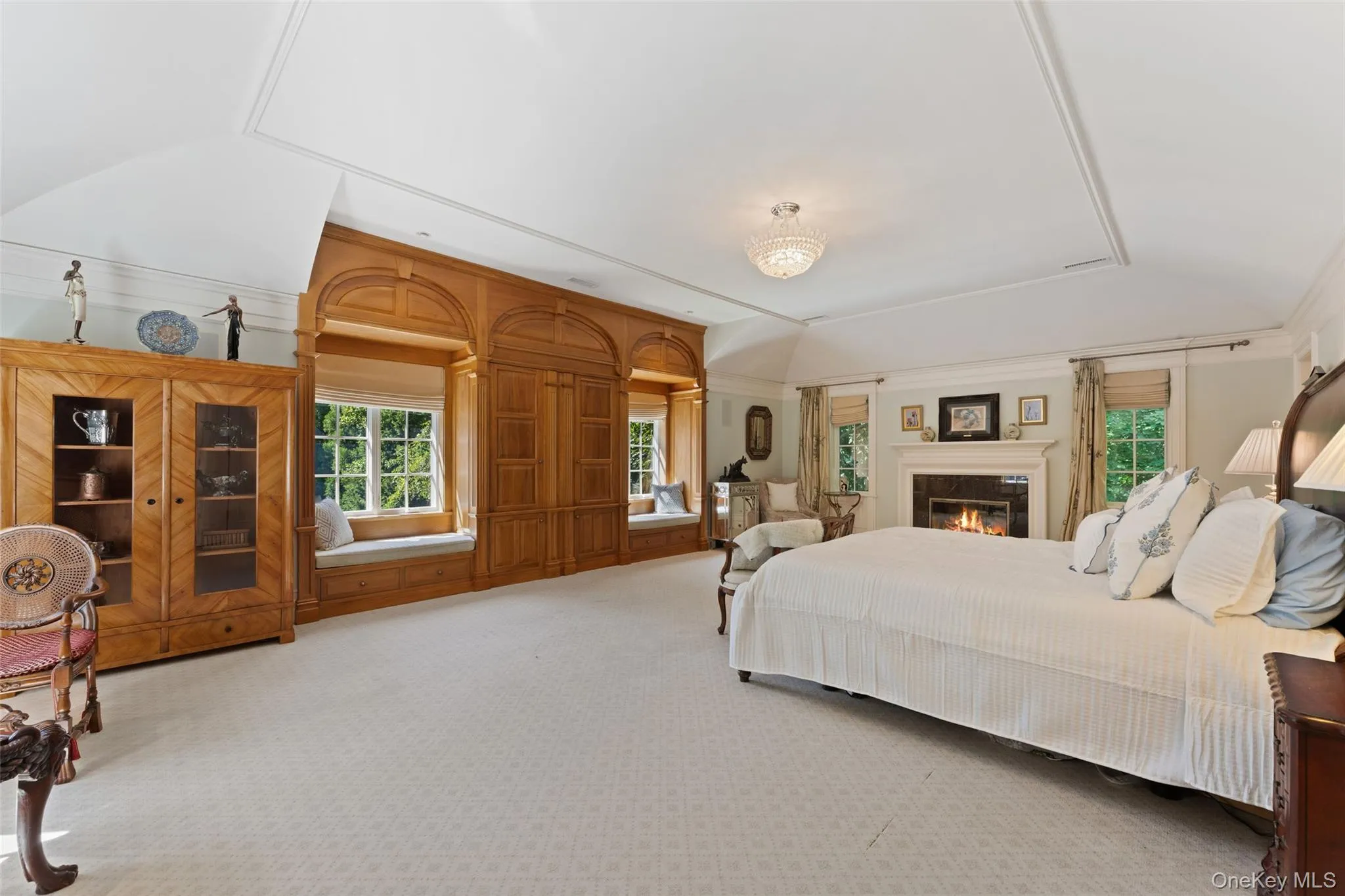 Oversized primary bedroom with vaulted ceiling and gas fireplace Oversized primary bedroom with vaulted ceiling and gas fireplace