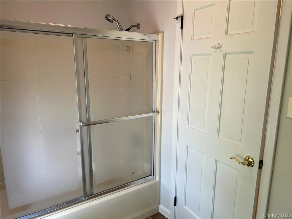 Bathroom with shower / bath combination with glass door Bathroom with shower / bath combination with glass door