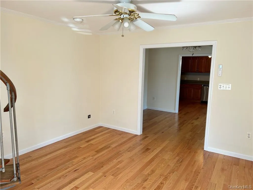 Unfurnished room with light hardwood / wood-style floors, crown molding, and ceiling fan Unfurnished room with light hardwood / wood-style floors, crown molding, and ceiling fan