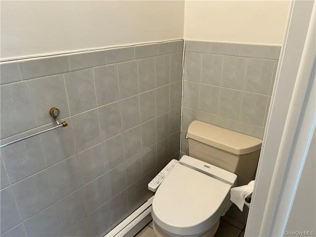 Bathroom with tile walls and toilet Bathroom with tile walls and toilet