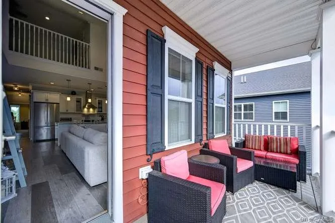 Outdoor Terrace with Cozy Sitting Area. View of Inside of Home. Outdoor Terrace with Cozy Sitting Area. View of Inside of Home.