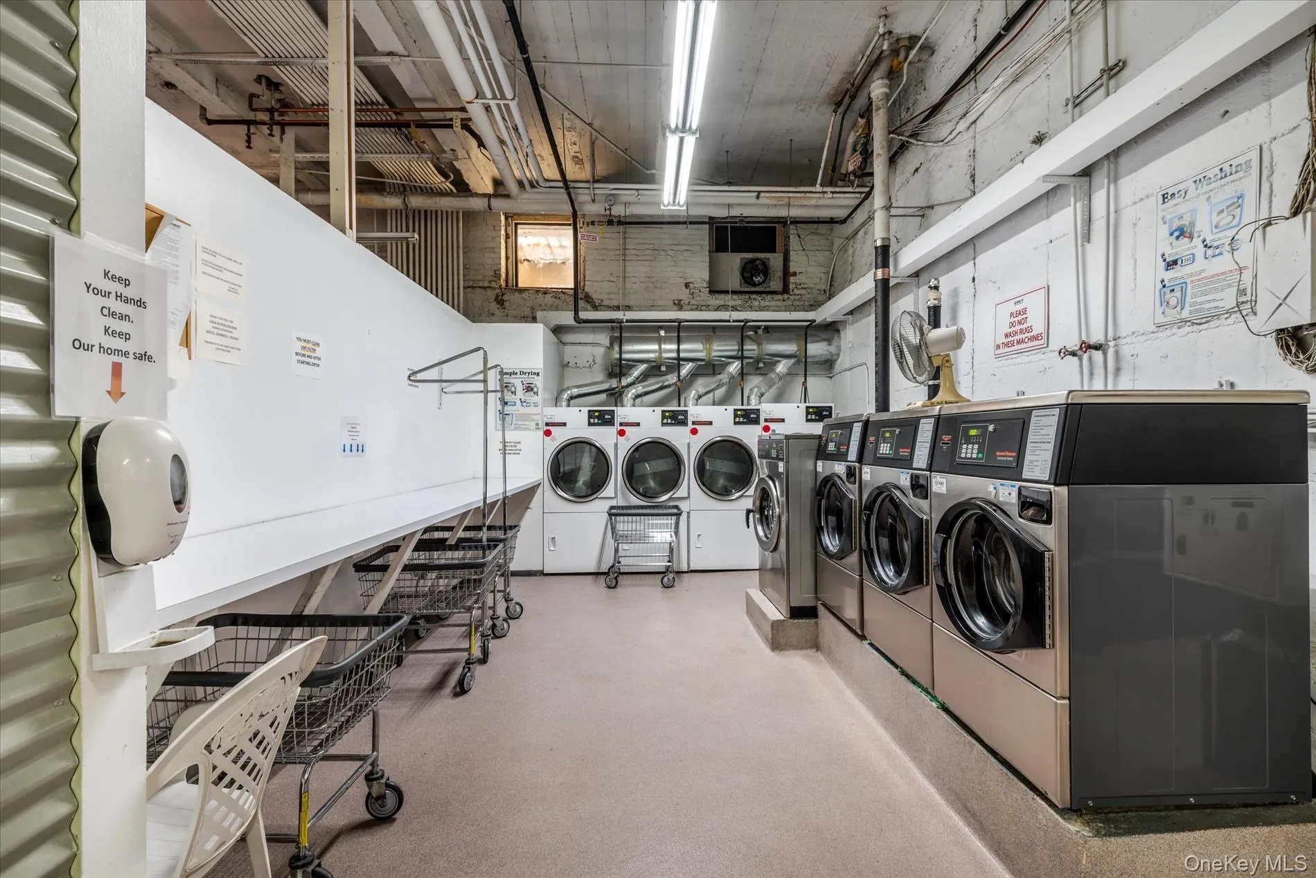 Dedicated laundry facility with multiple commercial-grade washing machines and dryers Dedicated laundry facility with multiple commercial-grade washing machines and dryers