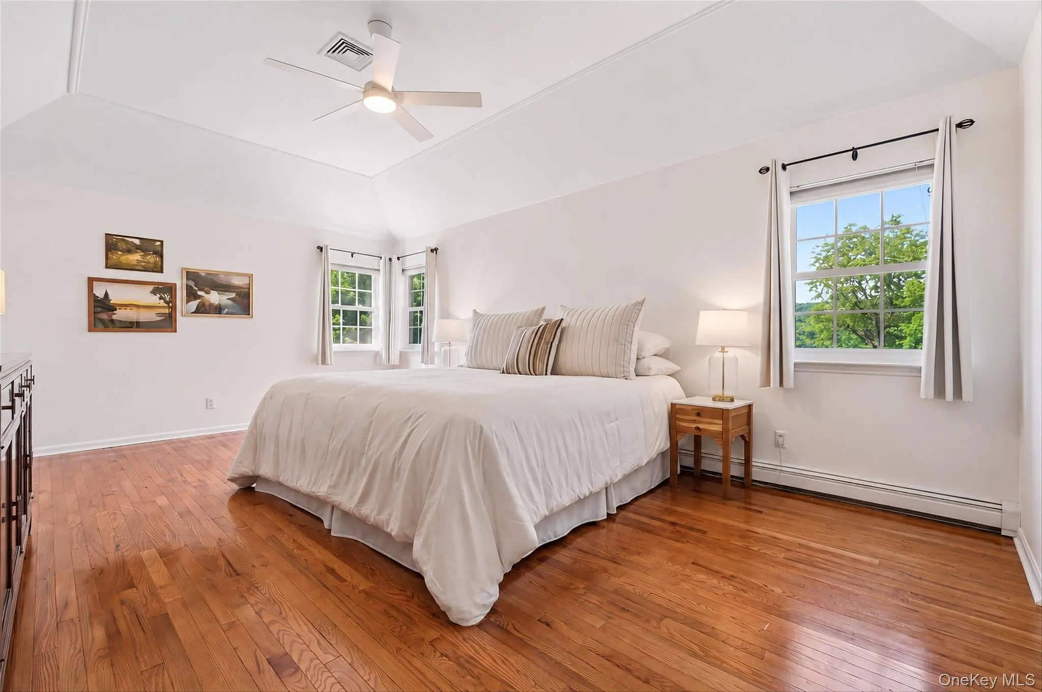 Spacious primary suite with beautiful hardwood floors and abundant natural light. Spacious primary suite with beautiful hardwood floors and abundant natural light.