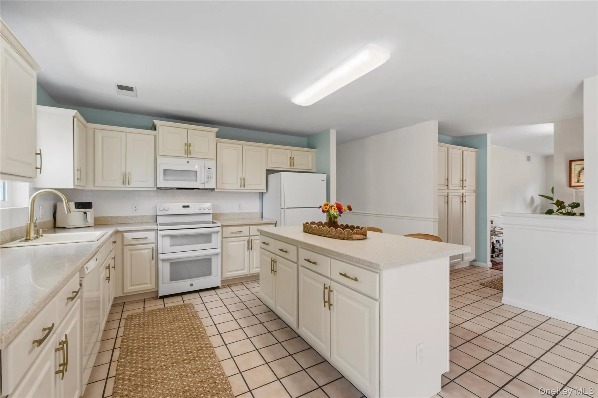 Spacious eat-in kitchen with generous cabinetry, counter space and center island. Spacious eat-in kitchen with generous cabinetry, counter space and center island.