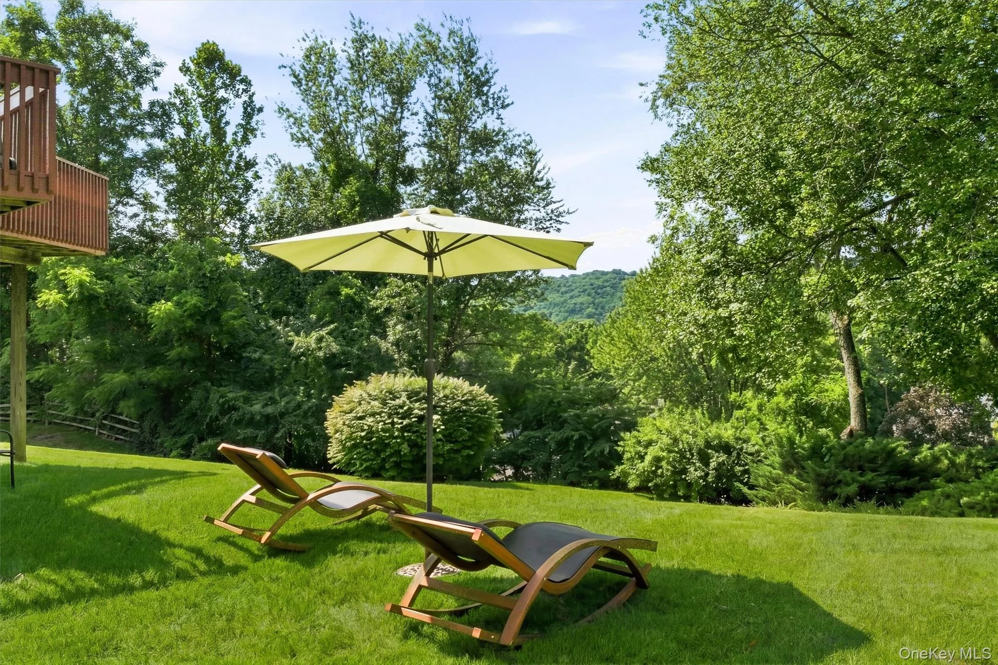A spacious backyard surrounded by mature trees and greenery. A spacious backyard surrounded by mature trees and greenery.