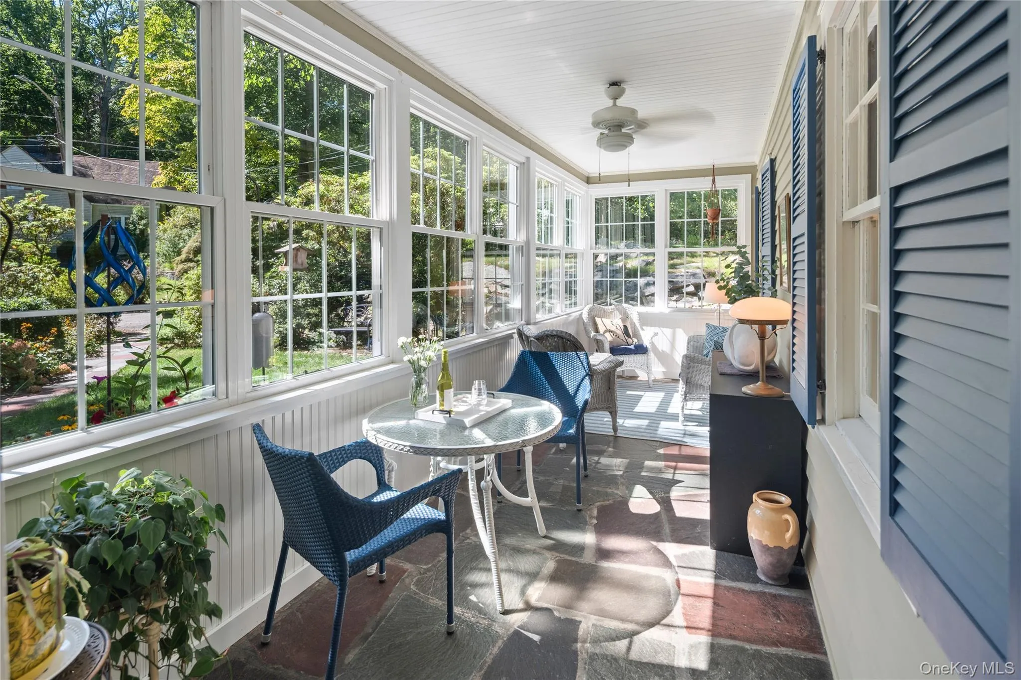 A wall of windows fills the room with natural sunlight and offers views of the front yard. A wall of windows fills the room with natural sunlight and offers views of the front yard.