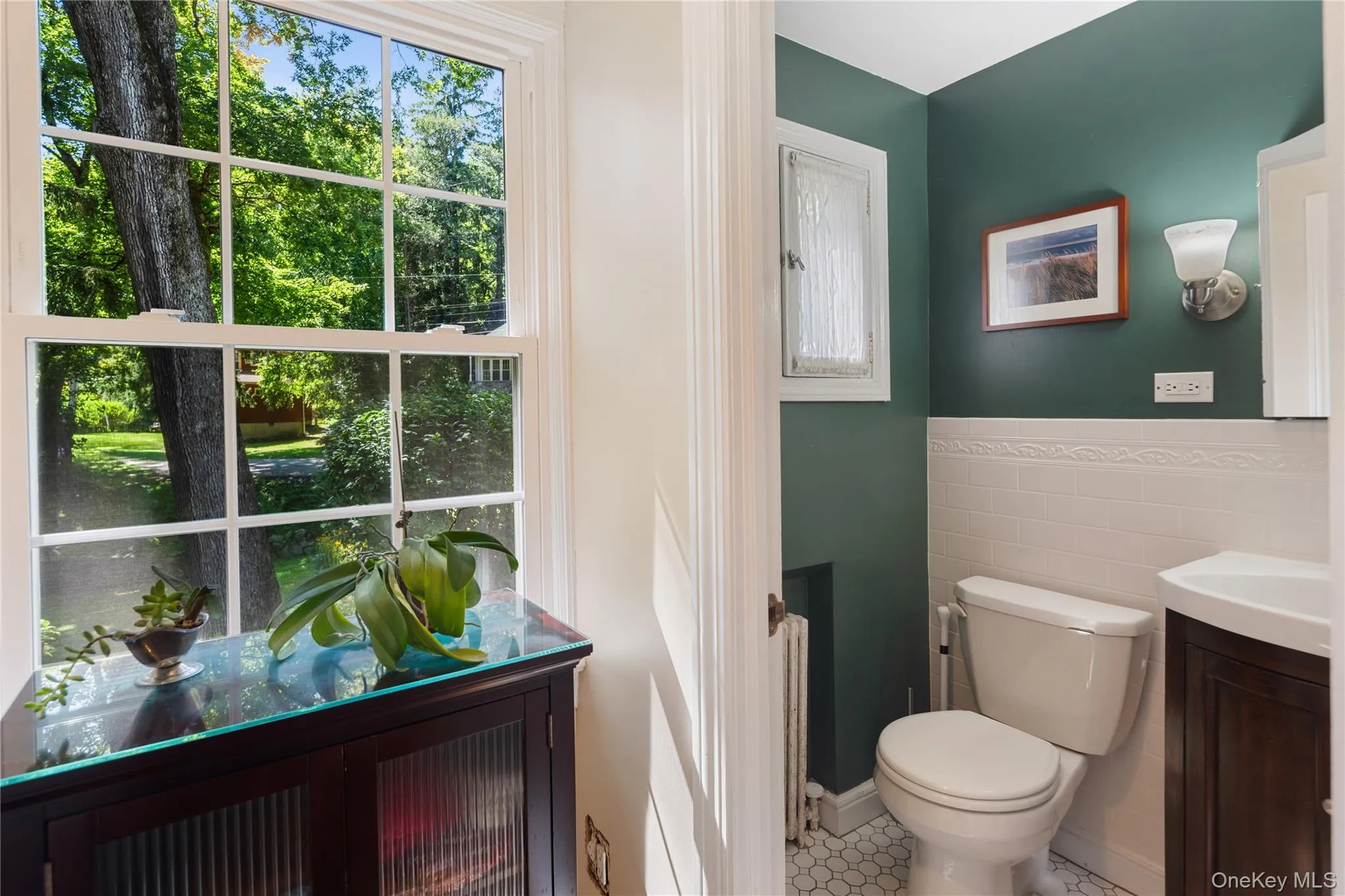 The main floor powder room features vintage details and added conveniences for guests. The main floor powder room features vintage details and added conveniences for guests.
