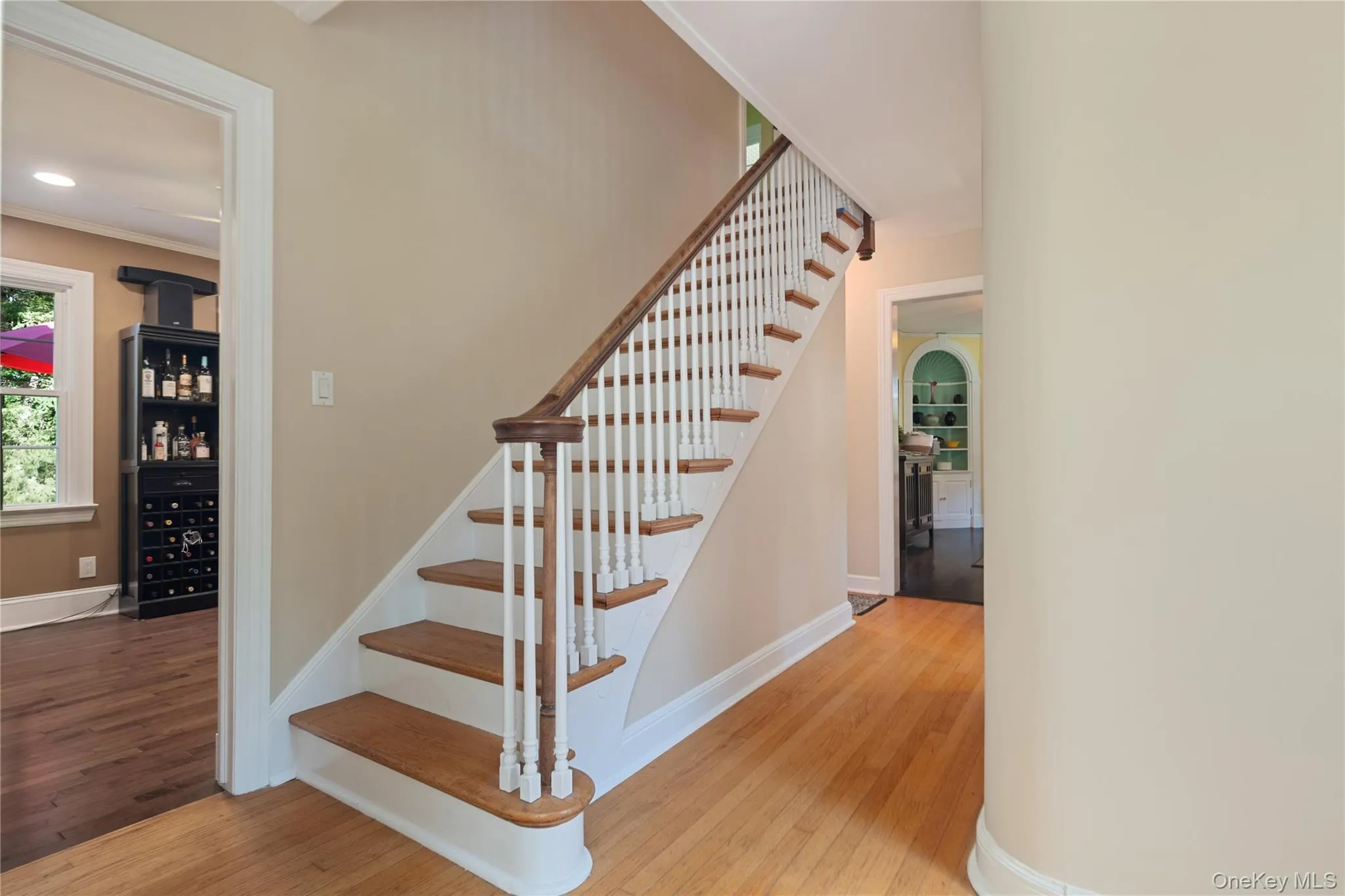 The entryway welcomes you with a vintage staircase and a convenient coat closet, leading seamlessly into the kitchen, dining area, living room, and a half bath. The layout offers a fantastic, easy flow. The entryway welcomes you with a vintage staircase and a convenient coat closet, leading seamlessly into the kitchen, dining area, living room, and a half bath. The layout offers a fantastic, easy flow.