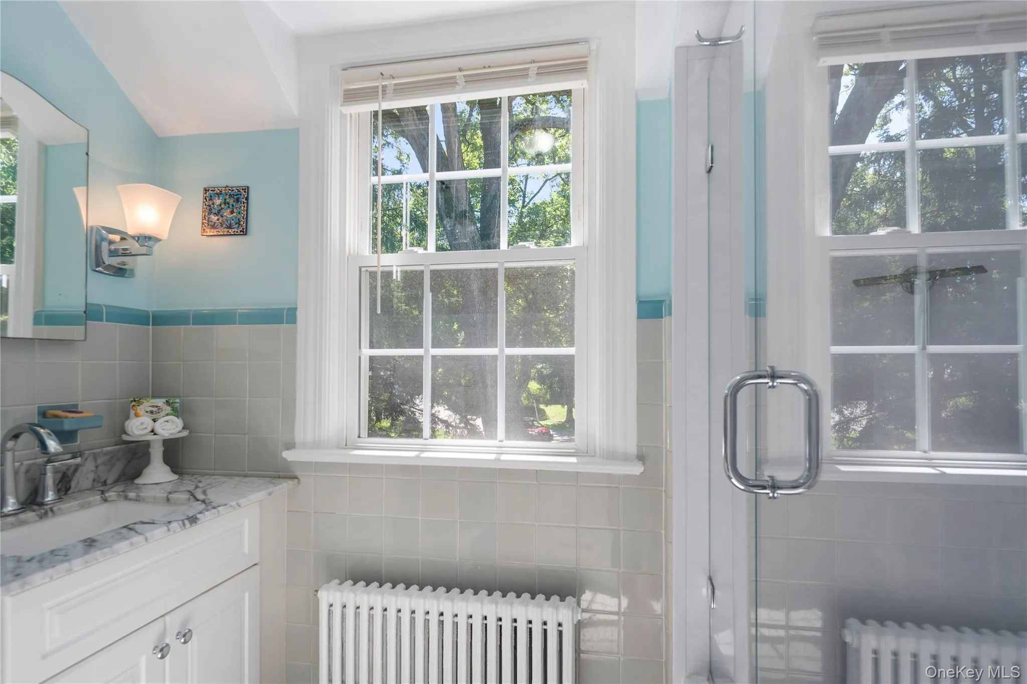 Renovated hall bath with glass shower w deep soaking tub, granite-top vanity, and unique decorative tiles. Renovated hall bath with glass shower w deep soaking tub, granite-top vanity, and unique decorative tiles.