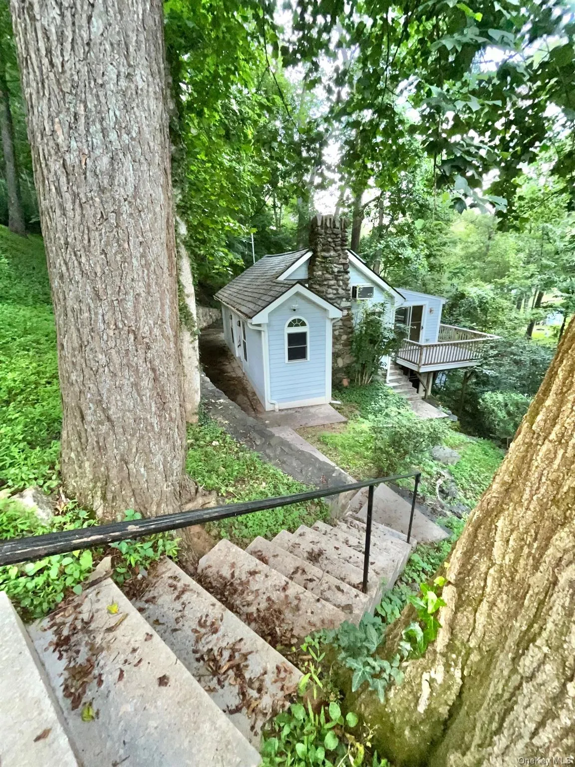 View of yard featuring a deck and an outbuilding View of yard featuring a deck and an outbuilding