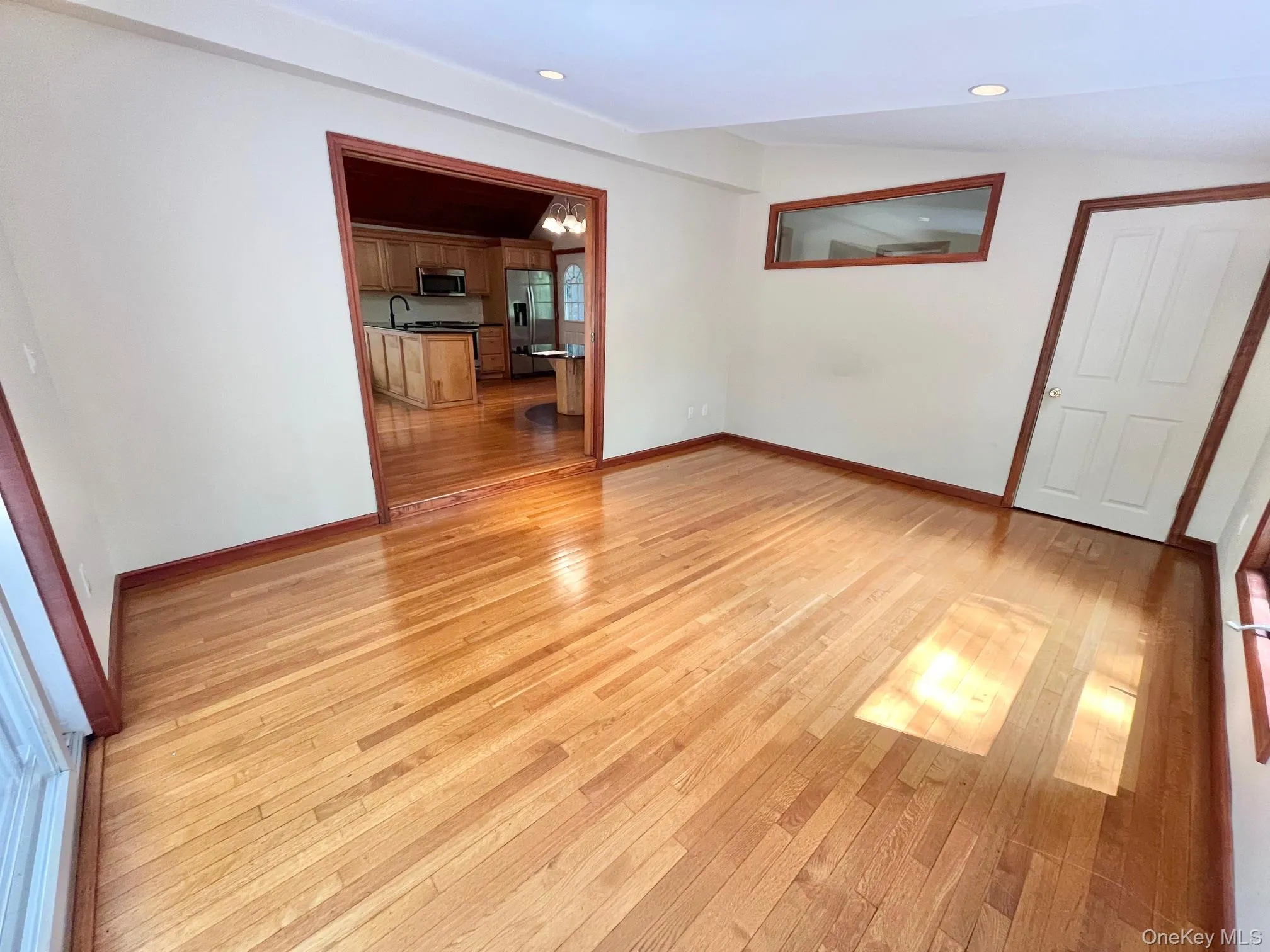 Empty room featuring light wood-style flooring, baseboards, and recessed lighting Empty room featuring light wood-style flooring, baseboards, and recessed lighting
