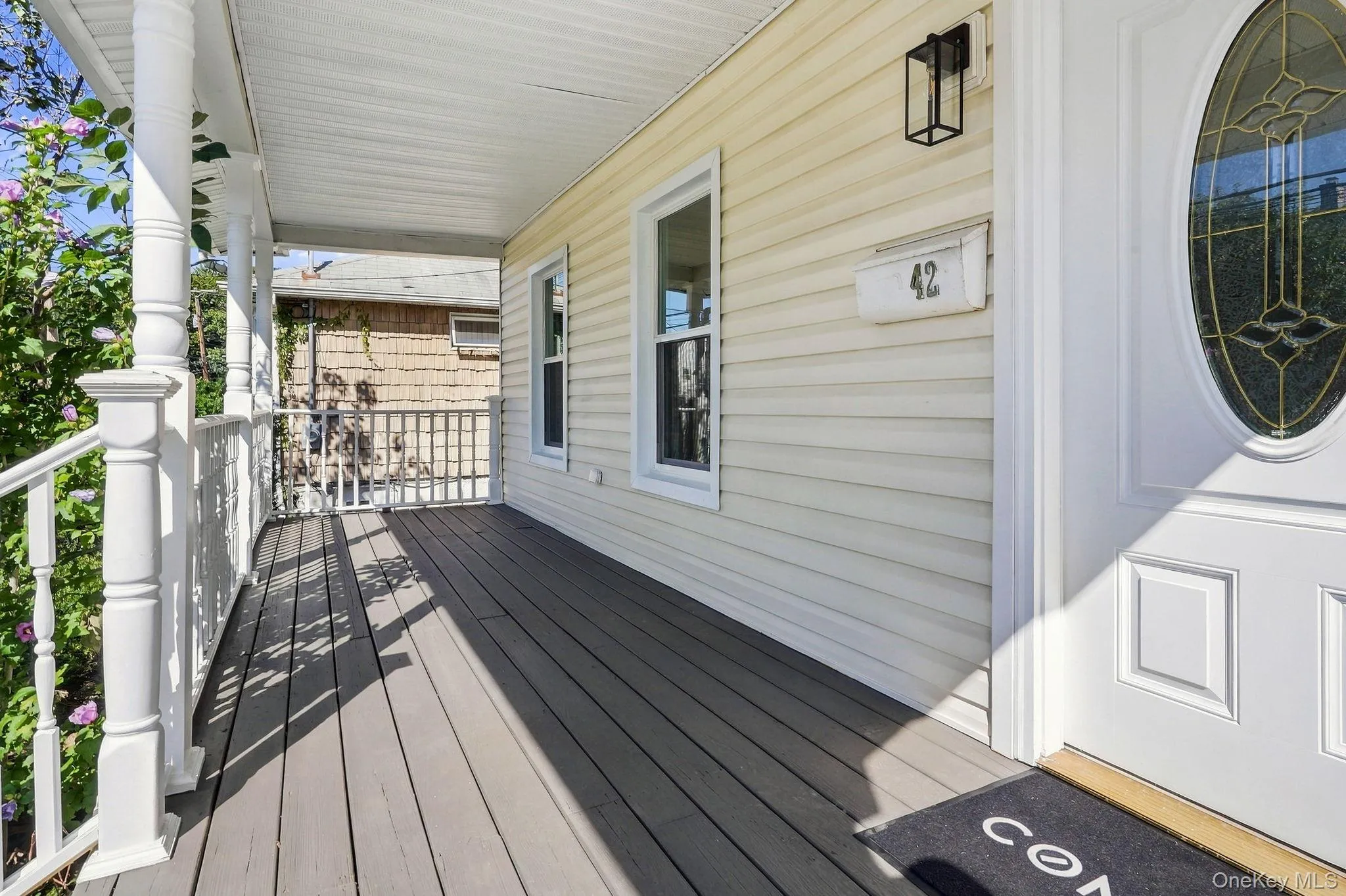 Enjoy a the large front porch featuring gray modern decking Enjoy a the large front porch featuring gray modern decking