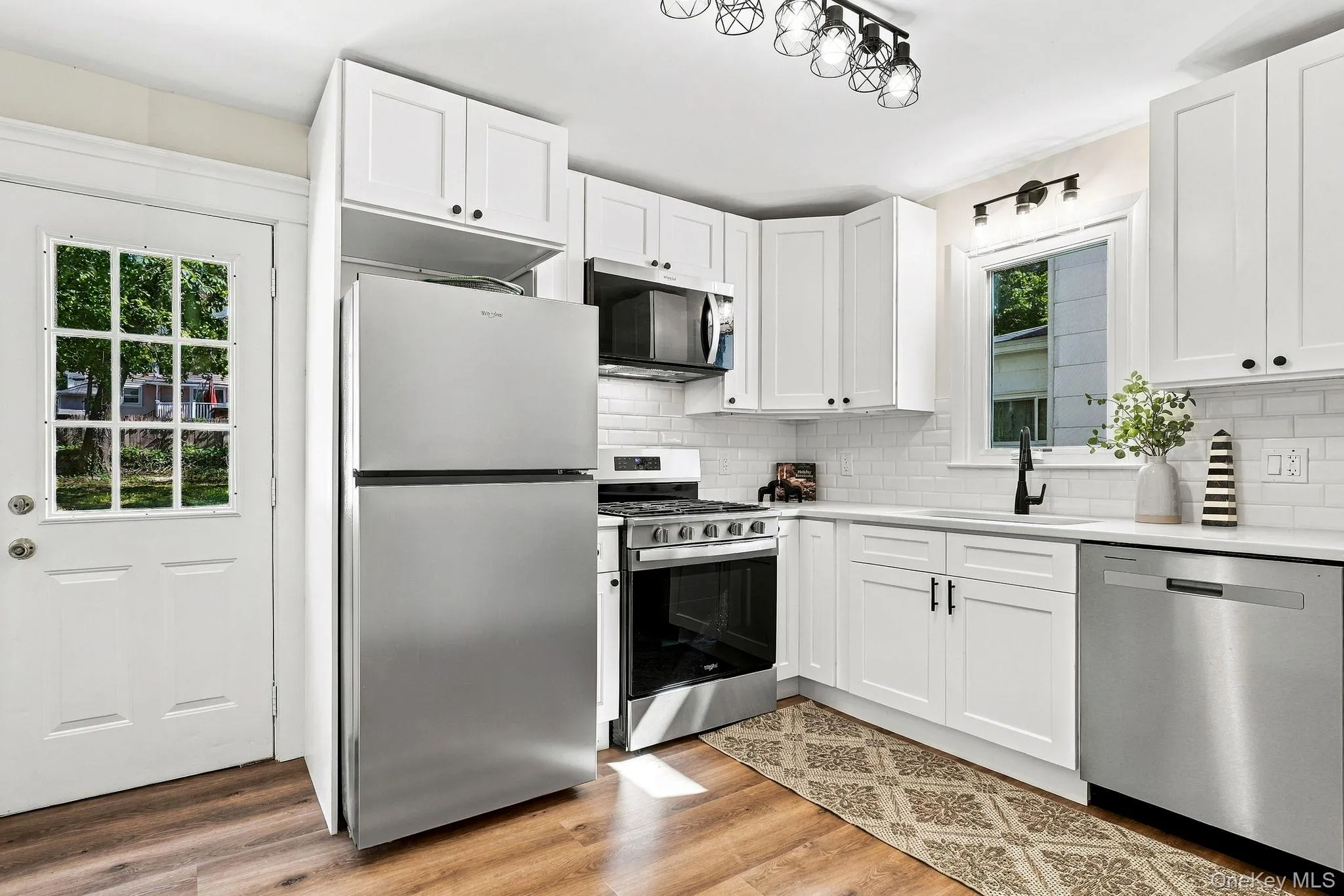Brand new white shaker cabinetry, stainless steel appliances, subway tile backsplash, and white countertops Brand new white shaker cabinetry, stainless steel appliances, subway tile backsplash, and white countertops