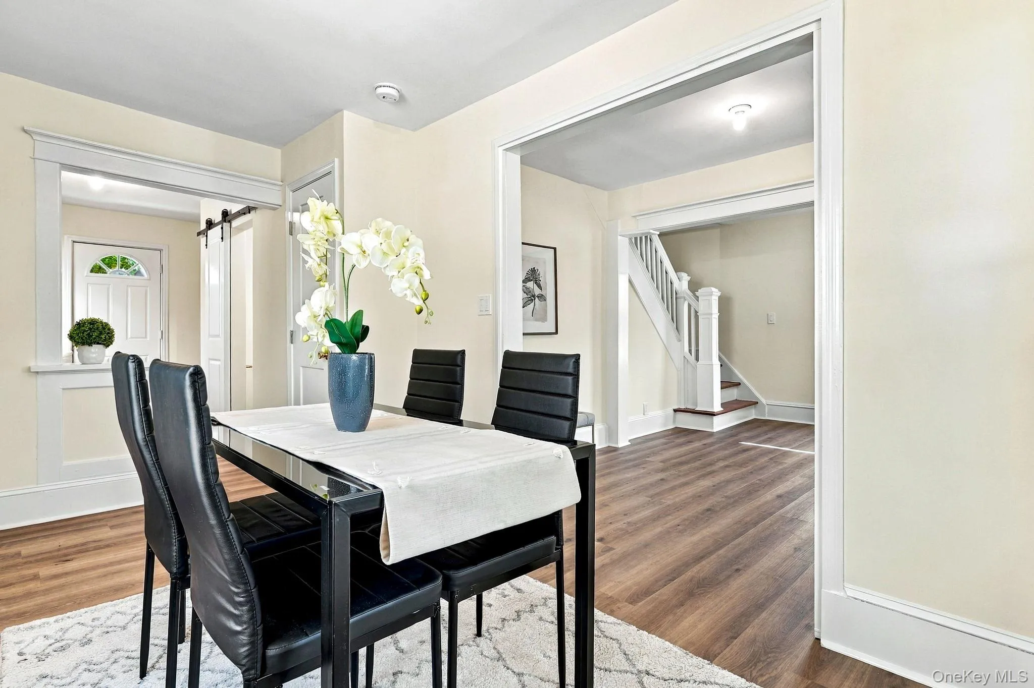 The dining space connects to the living room on one side and to the hall and the kitchen on the other The dining space connects to the living room on one side and to the hall and the kitchen on the other