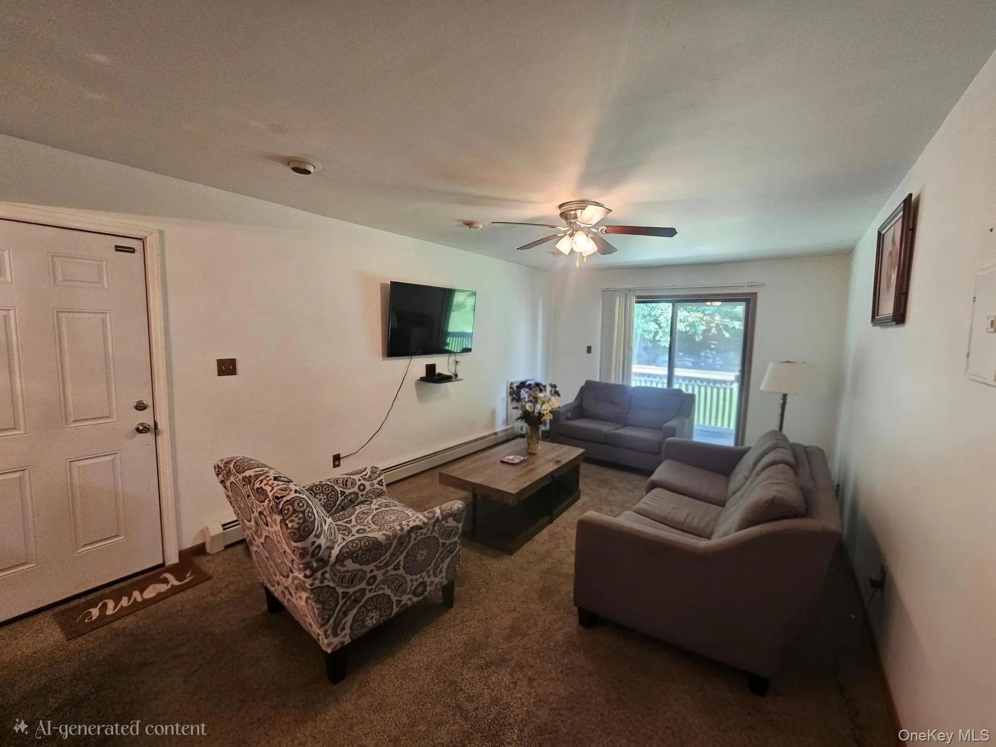 Living area featuring a ceiling fan, wall-mounted television, sliding glass door, and carpet flooring Living area featuring a ceiling fan, wall-mounted television, sliding glass door, and carpet flooring