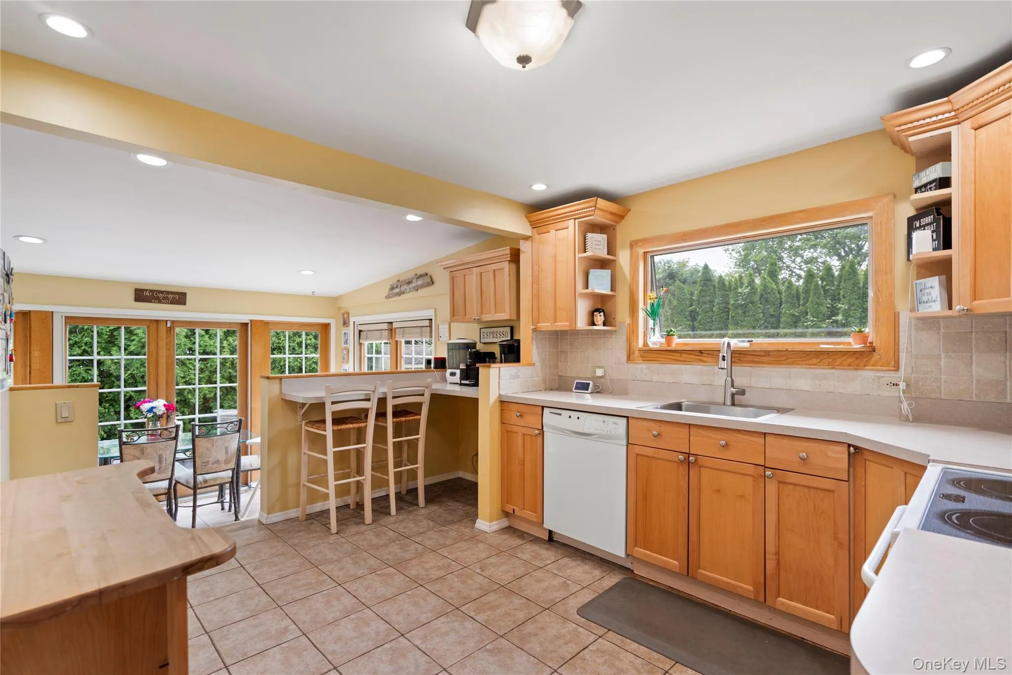 Kitchen featuring dishwasher, a sink, open shelves, healthy amount of natural light, and recessed lighting Kitchen featuring dishwasher, a sink, open shelves, healthy amount of natural light, and recessed lighting