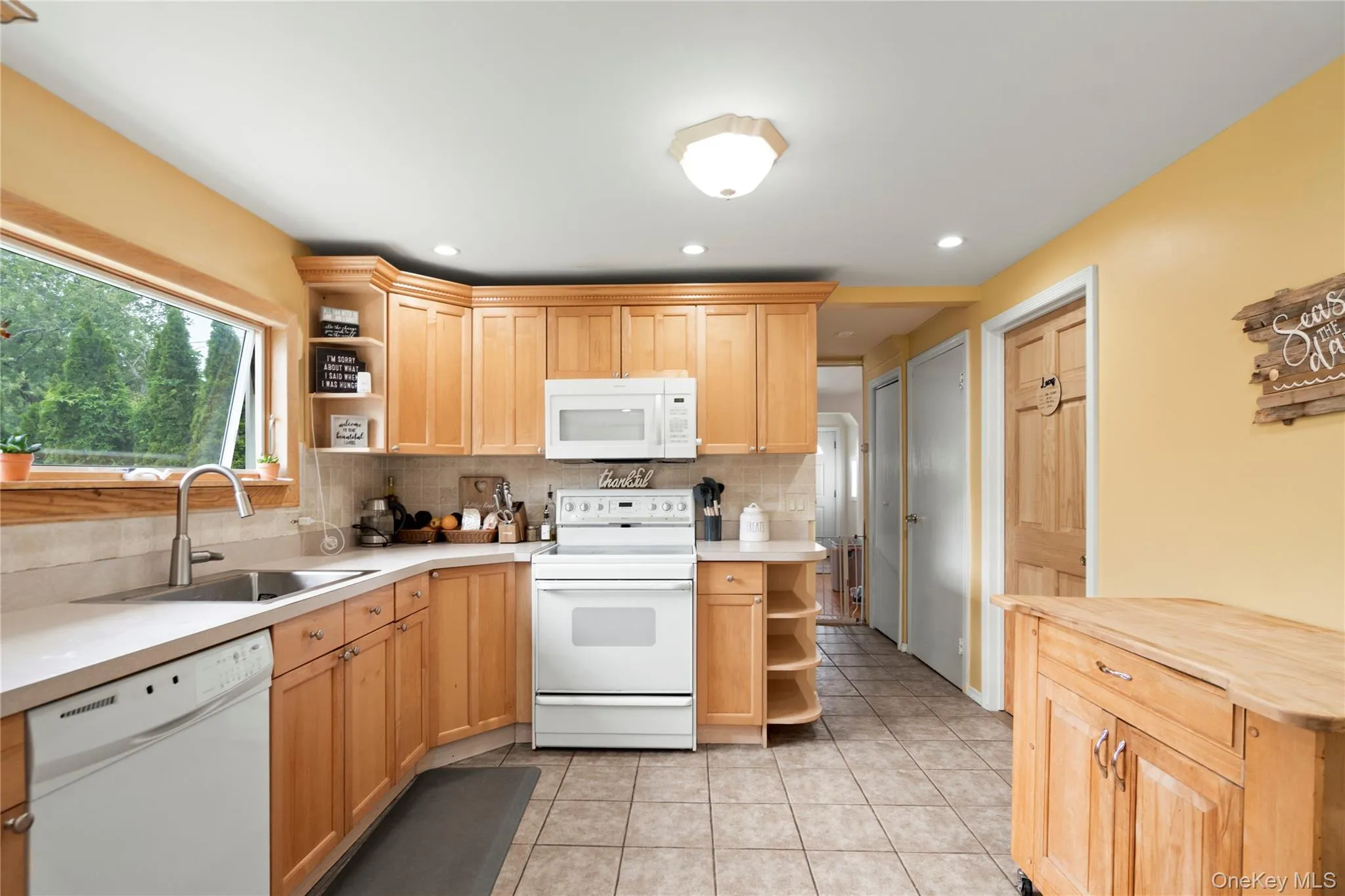 Kitchen featuring white appliances, open shelves, a sink, decorative backsplash, and recessed lighting Kitchen featuring white appliances, open shelves, a sink, decorative backsplash, and recessed lighting
