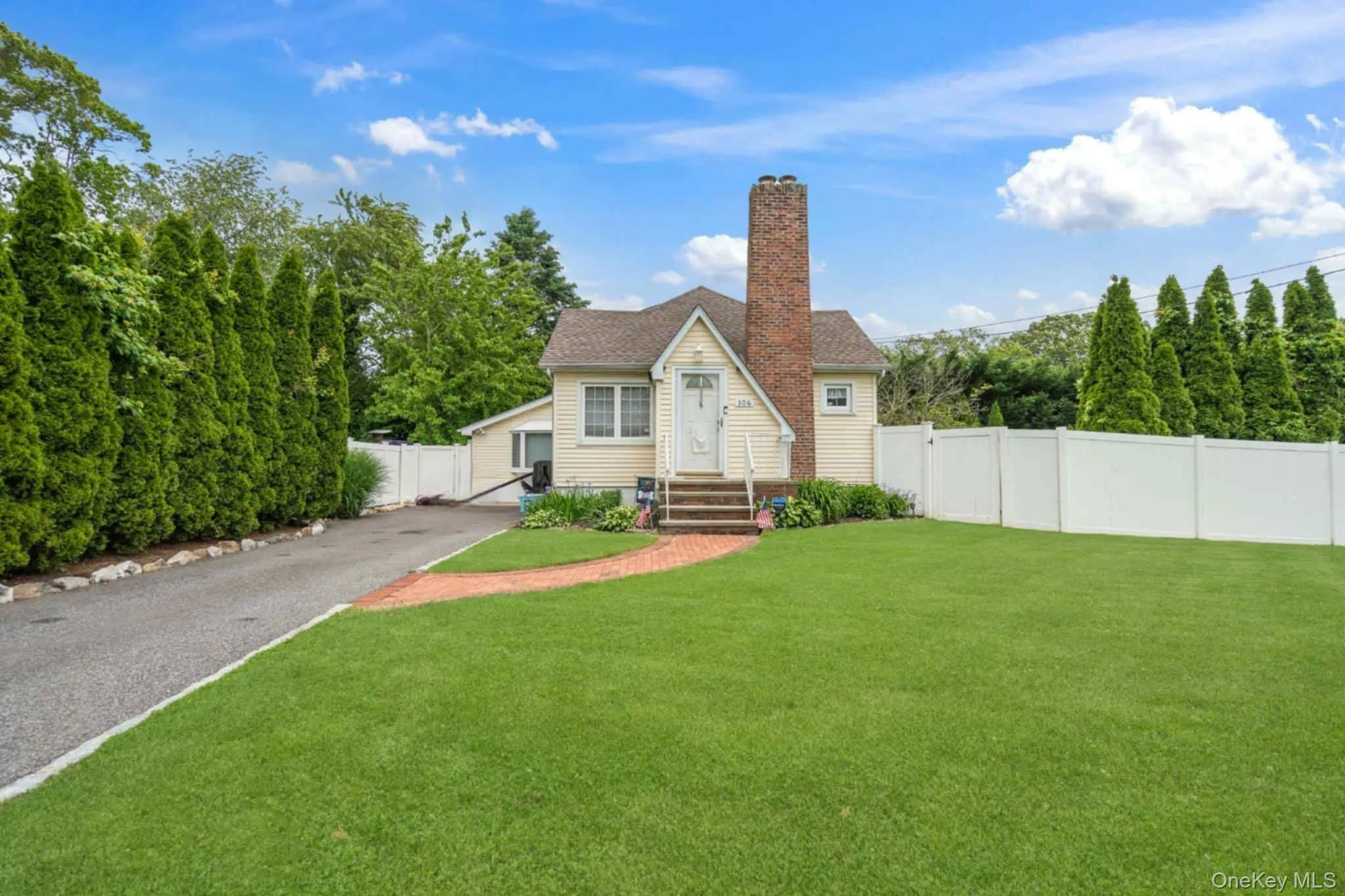 Bungalow featuring a chimney and entry steps Bungalow featuring a chimney and entry steps