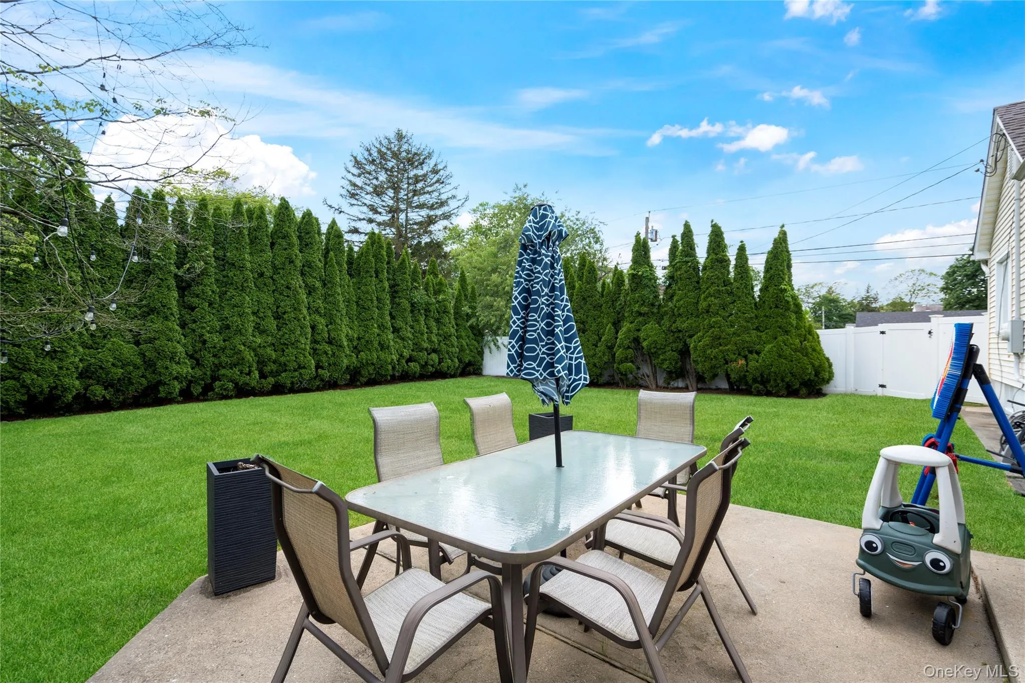 View of patio / terrace with outdoor dining area and a gate View of patio / terrace with outdoor dining area and a gate