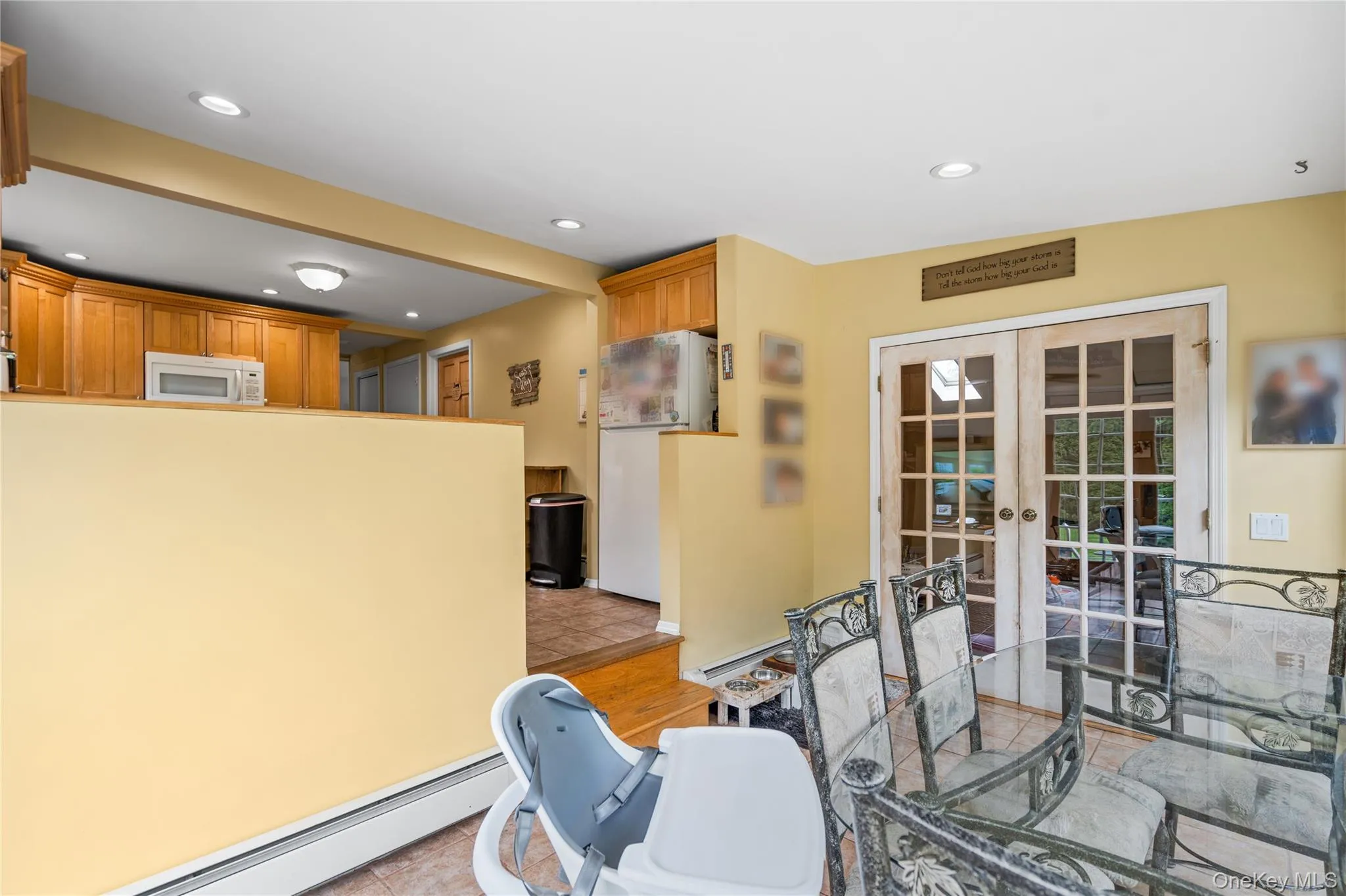 Dining space with french doors, recessed lighting, and a baseboard heating unit Dining space with french doors, recessed lighting, and a baseboard heating unit