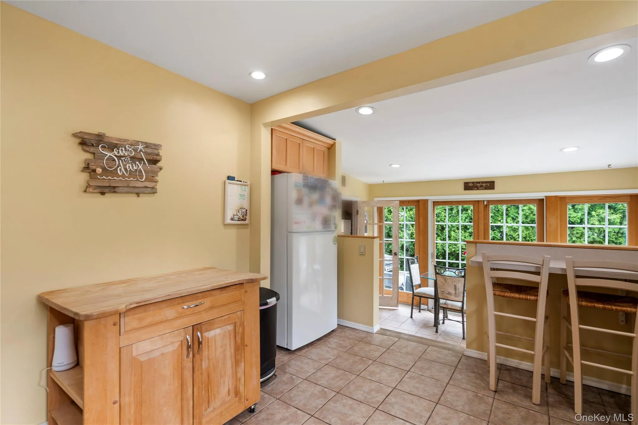 Kitchen with freestanding refrigerator, open shelves, recessed lighting, light tile patterned floors, and light brown cabinets Kitchen with freestanding refrigerator, open shelves, recessed lighting, light tile patterned floors, and light brown cabinets
