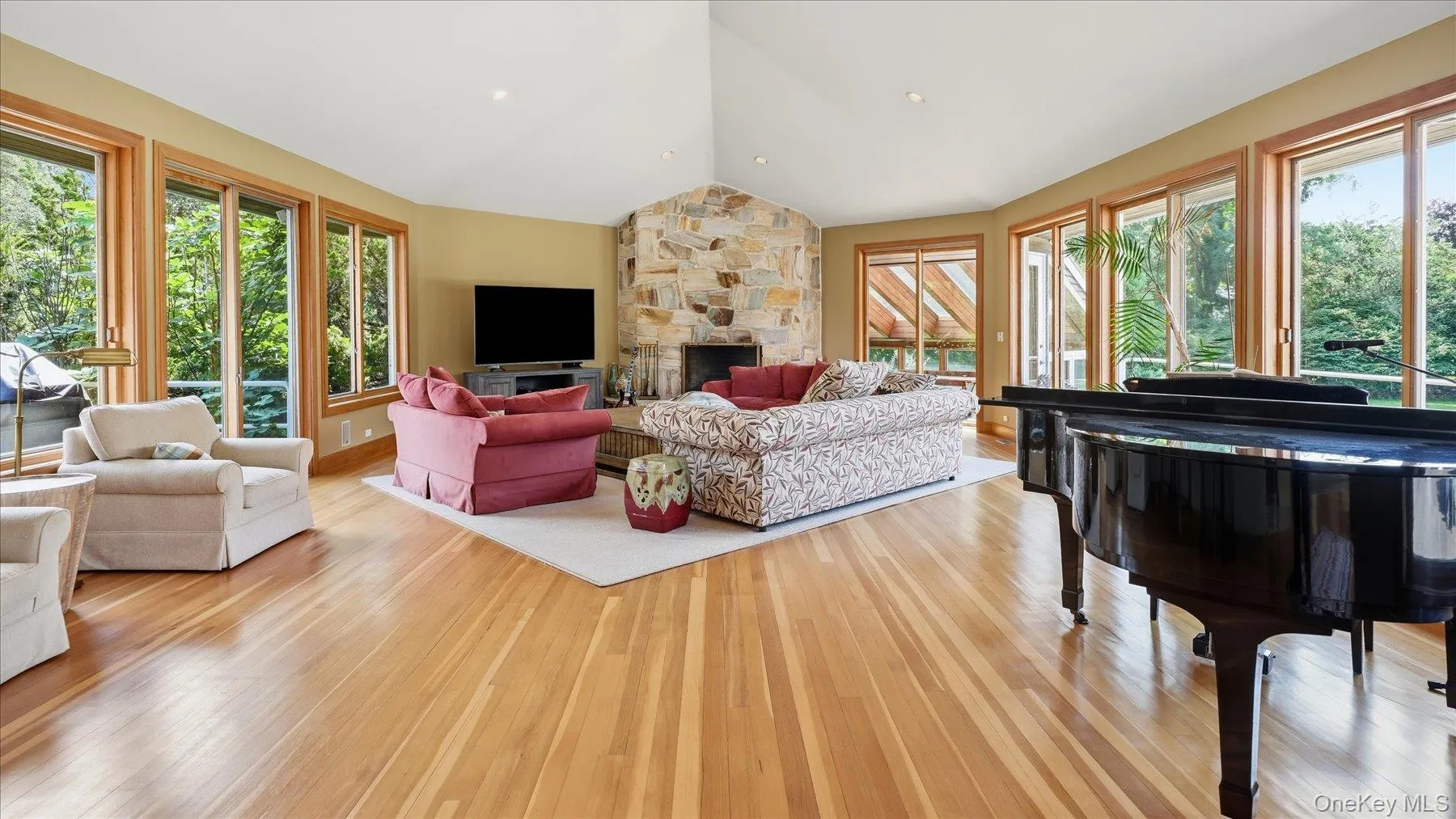 Expansive great room with stone fireplace and exit to personal greenhouse. Expansive great room with stone fireplace and exit to personal greenhouse.