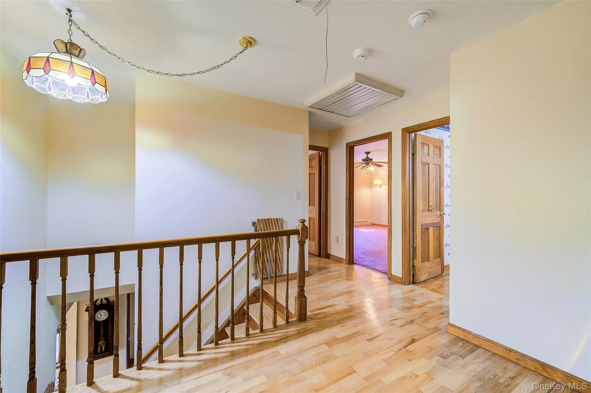Hardwood flooring throughout the hallway/stairs to second floor with natural wood doors and trim Hardwood flooring throughout the hallway/stairs to second floor with natural wood doors and trim