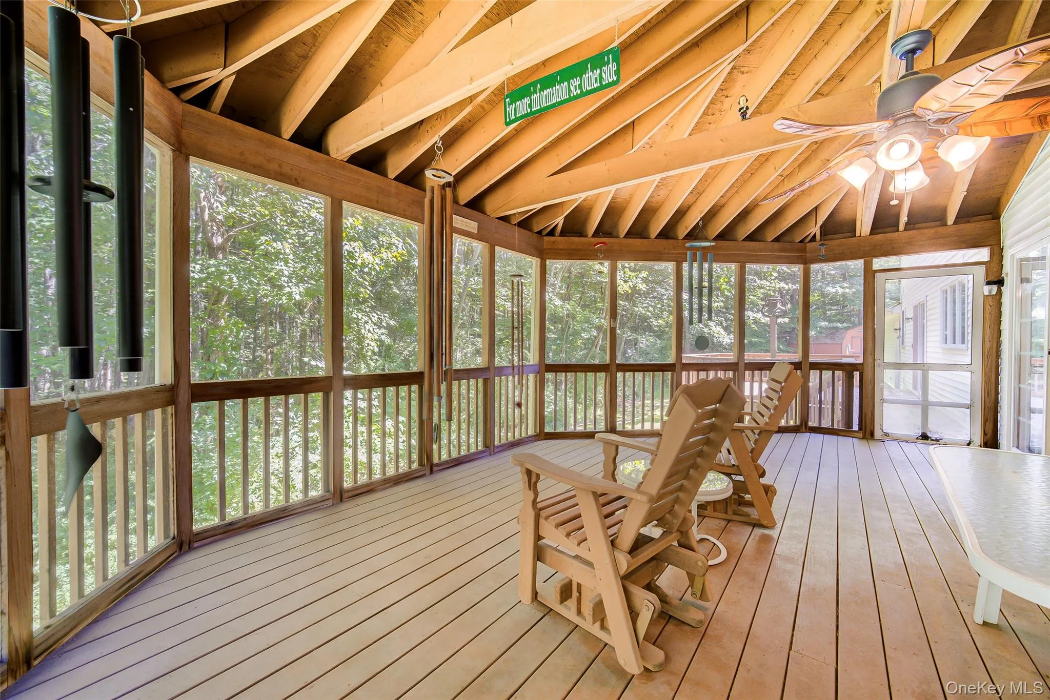 Tremendous screened outdoor deck with a wood-finish ceiling, exposed beams, and a ceiling fan with integrated lighting Tremendous screened outdoor deck with a wood-finish ceiling, exposed beams, and a ceiling fan with integrated lighting