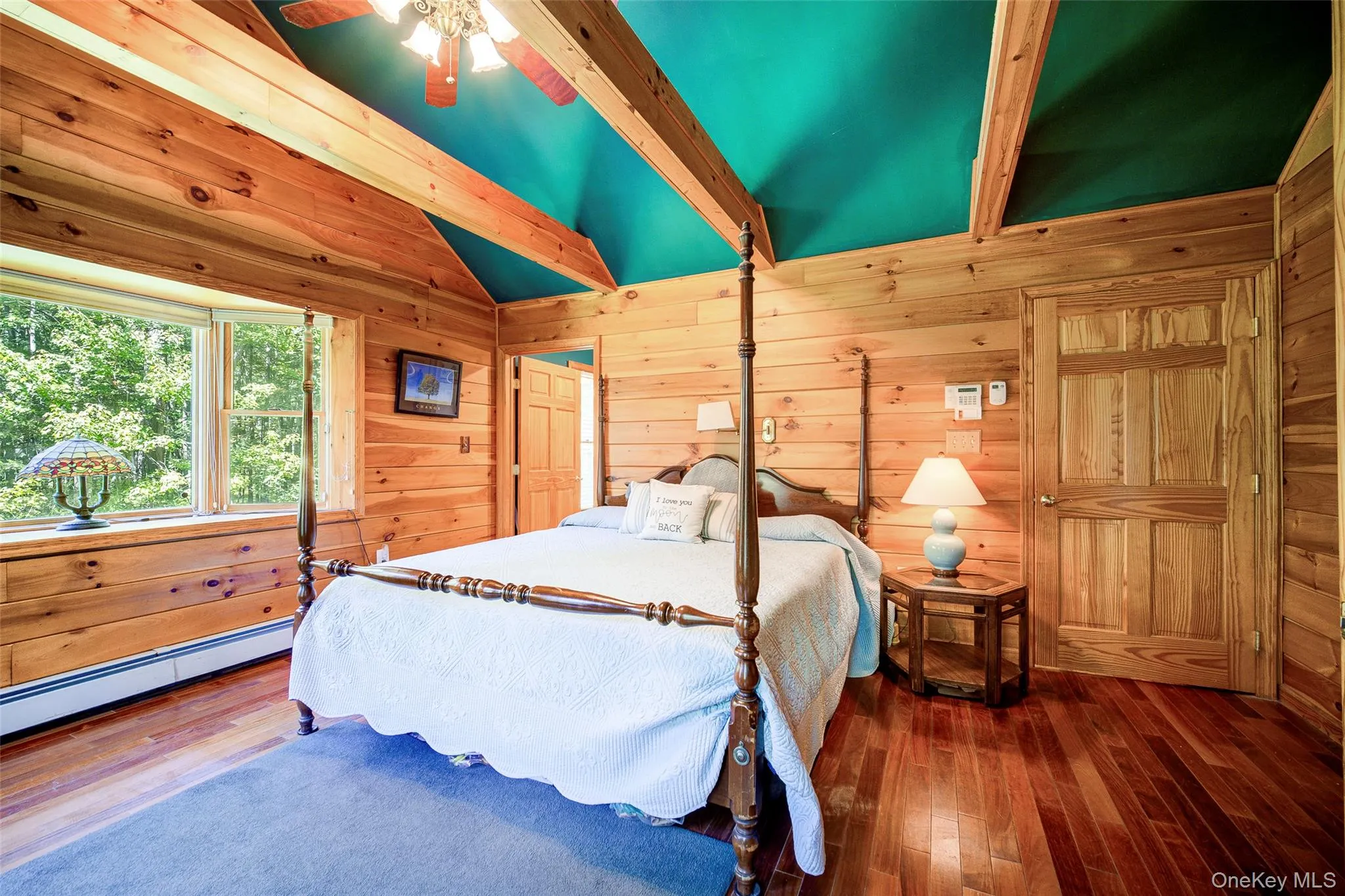 Wood-paneled walls and ceiling with exposed wood beams Wood-paneled walls and ceiling with exposed wood beams