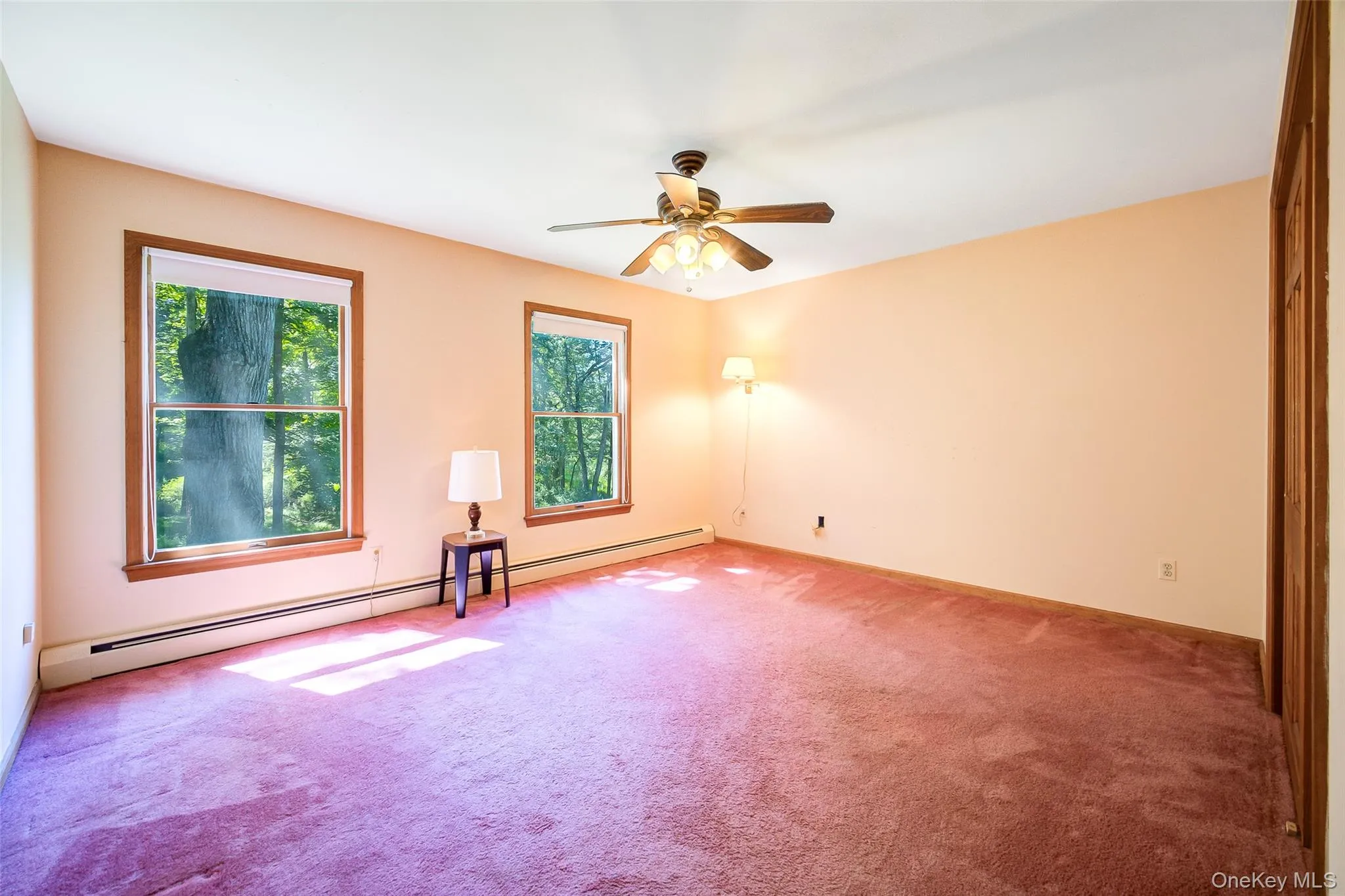 Bedroom #3 carpeted with a large closet, front facing windows and a ceiling fan. Bedroom #3 carpeted with a large closet, front facing windows and a ceiling fan.