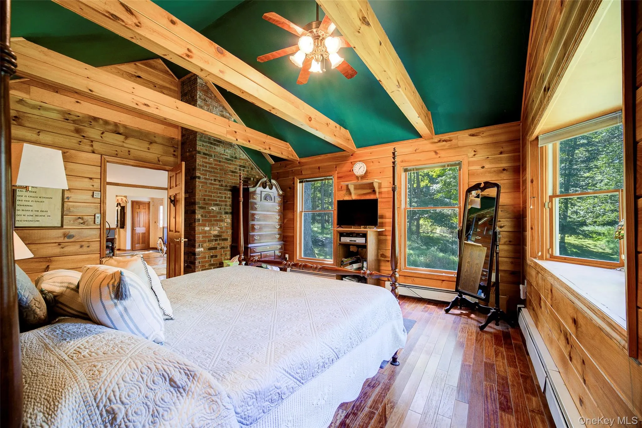 Wood-paneled walls and exposed ceiling beams with a ceiling fan. Wood-paneled walls and exposed ceiling beams with a ceiling fan.