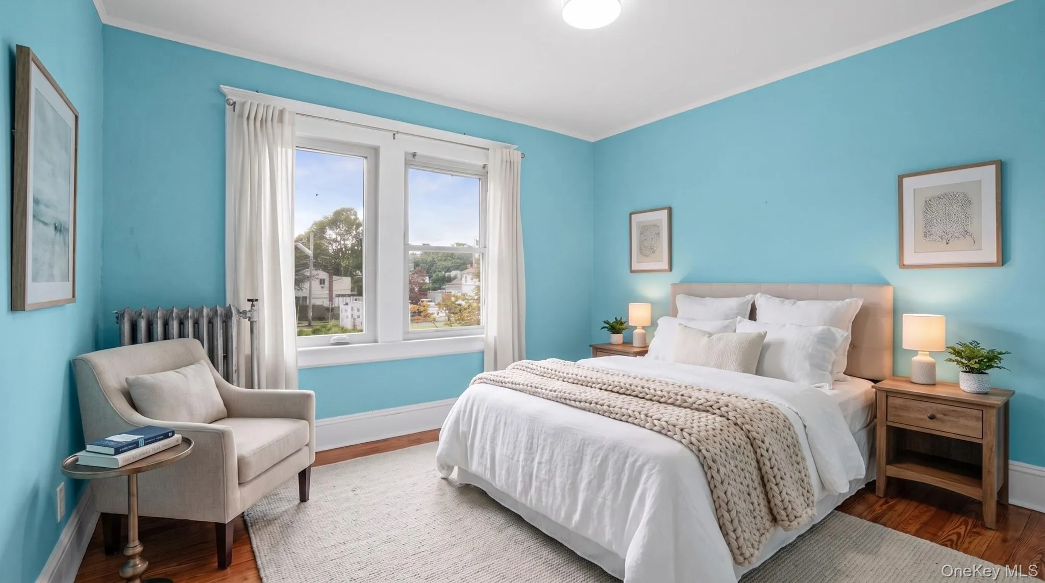 Hardwood flooring, white trim, and a prominent window Hardwood flooring, white trim, and a prominent window