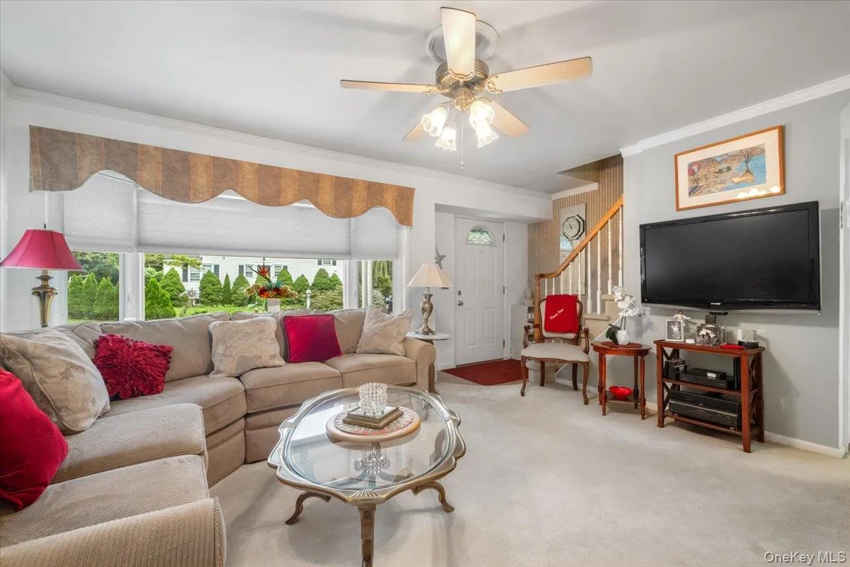 Sunlit living room with large bay window. Sunlit living room with large bay window.