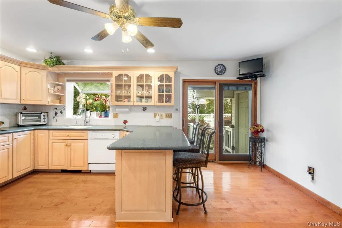 From the kitchen enjoy easy access to the outdoor deck and backyard via sliding glass doors. From the kitchen enjoy easy access to the outdoor deck and backyard via sliding glass doors.